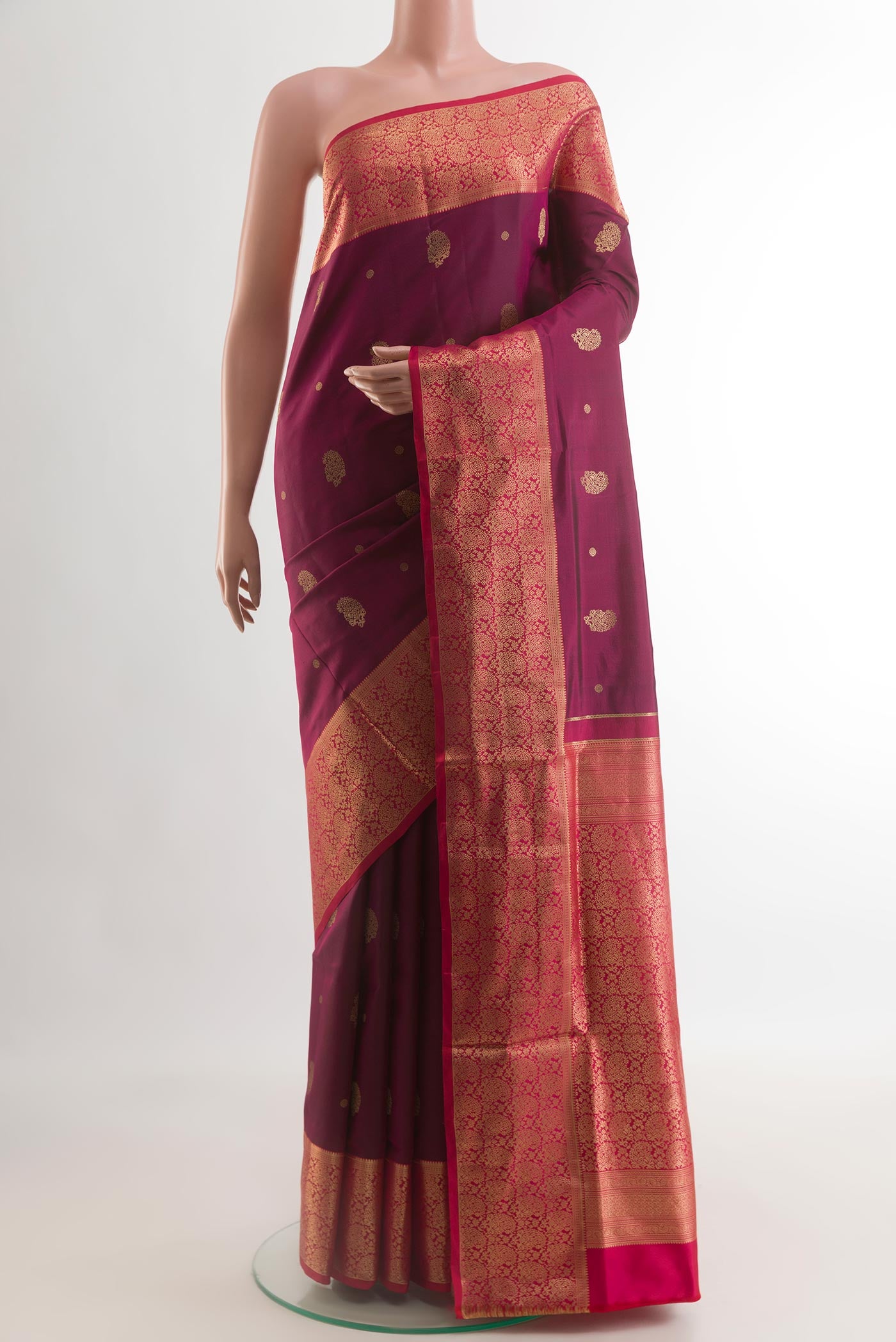 Maroon Soft Silk Saree with Zari Butta on the body and Zari Border.  displayed on a mannequin