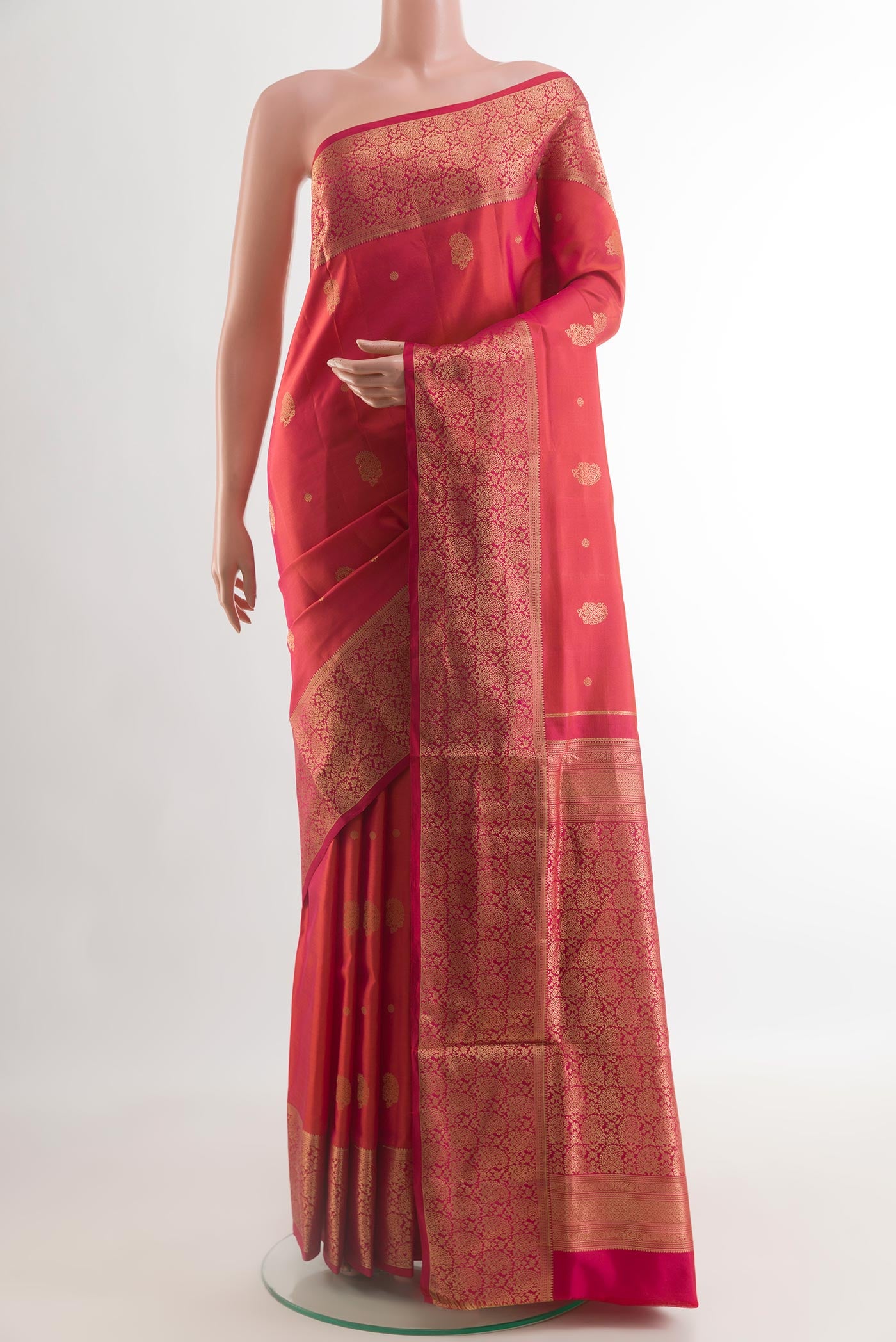 Coral Soft Silk Saree with Zari Butta on the body and Zari Border.  displayed on a mannequin