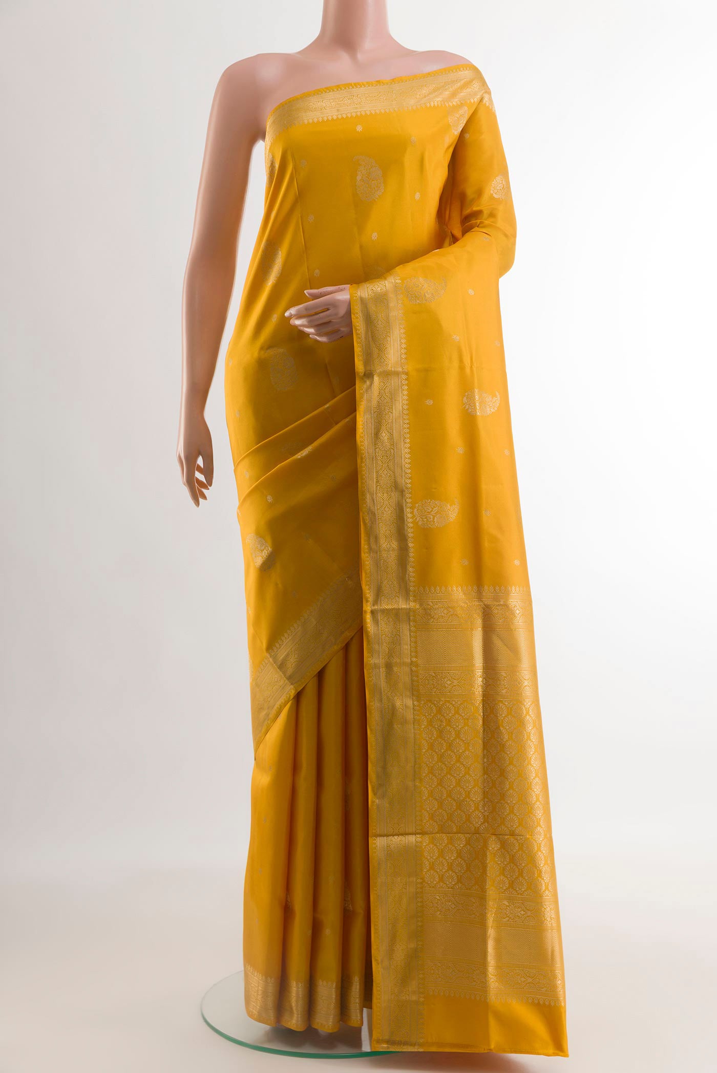 Yellow Soft Silk Saree with Zari Butta on the body and Zari Border.  displayed on a mannequin
