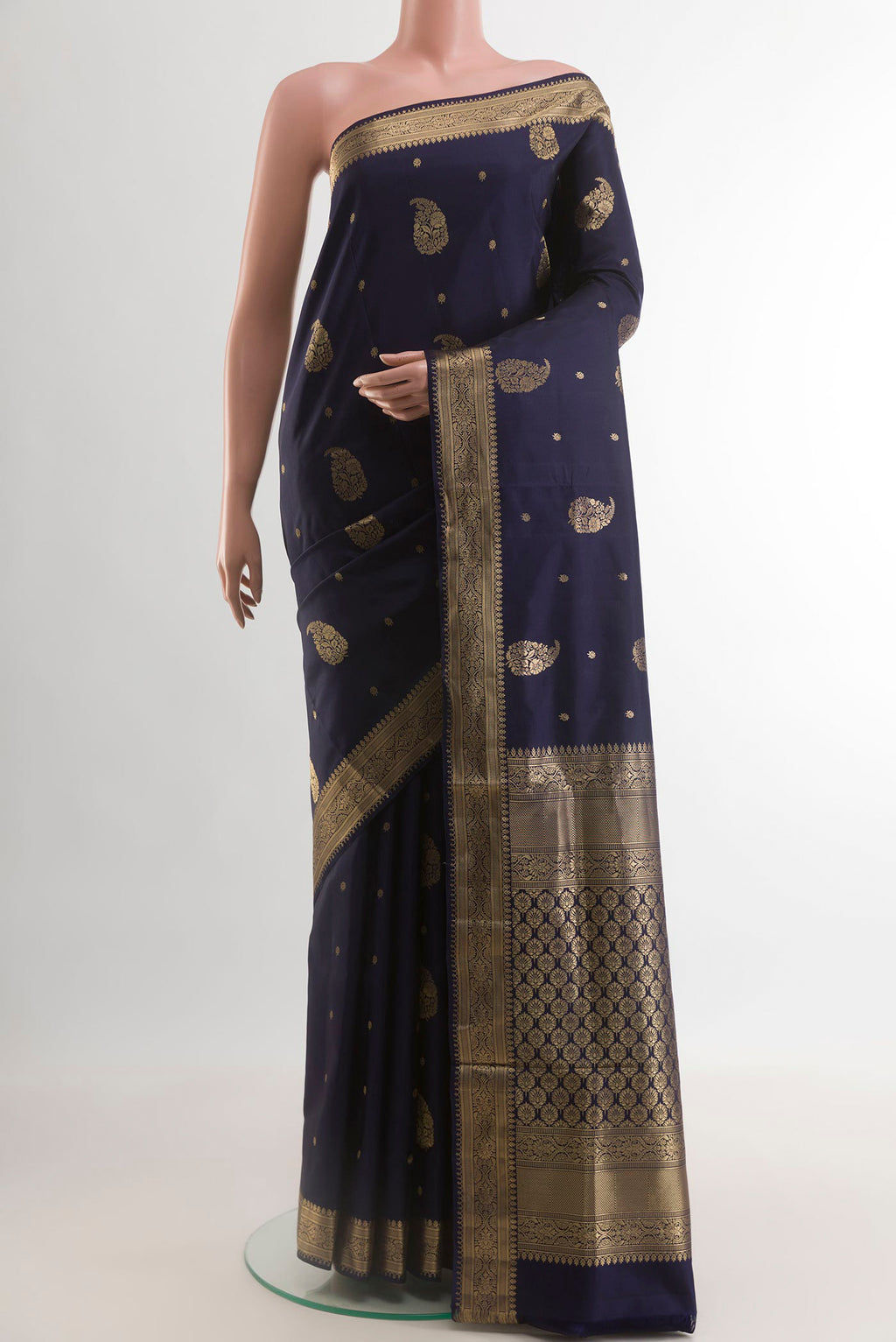 Navy Blue Soft Silk Saree with Zari Butta on the body and Zari Border.  displayed on a mannequin