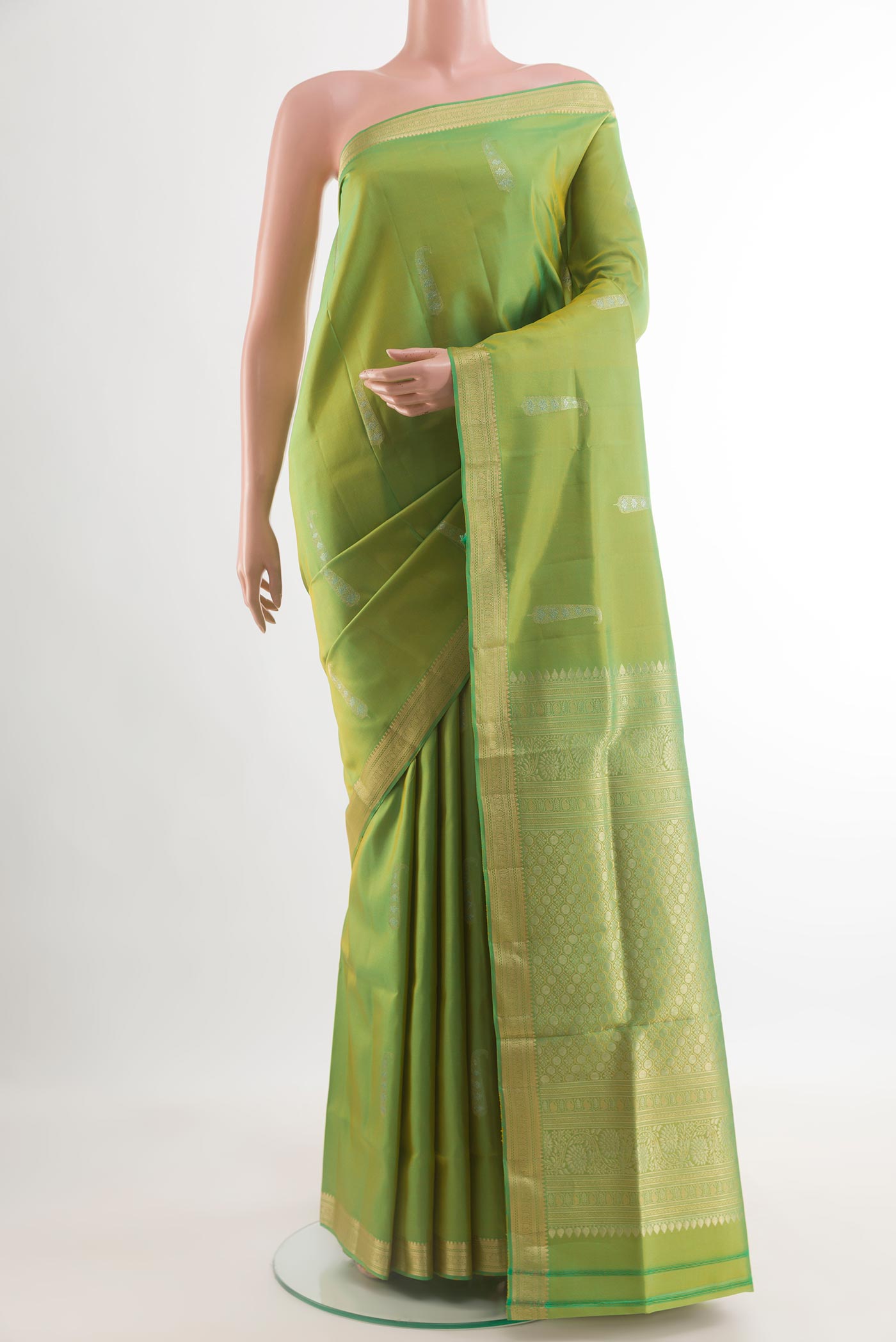 Green Soft Silk Saree with Zari Butta on the body and Zari Border.  displayed on a mannequin
