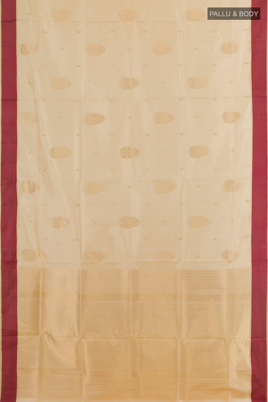 Flat view of Cream Soft Silk Saree with Zari Butta on the body and Thread Border. 