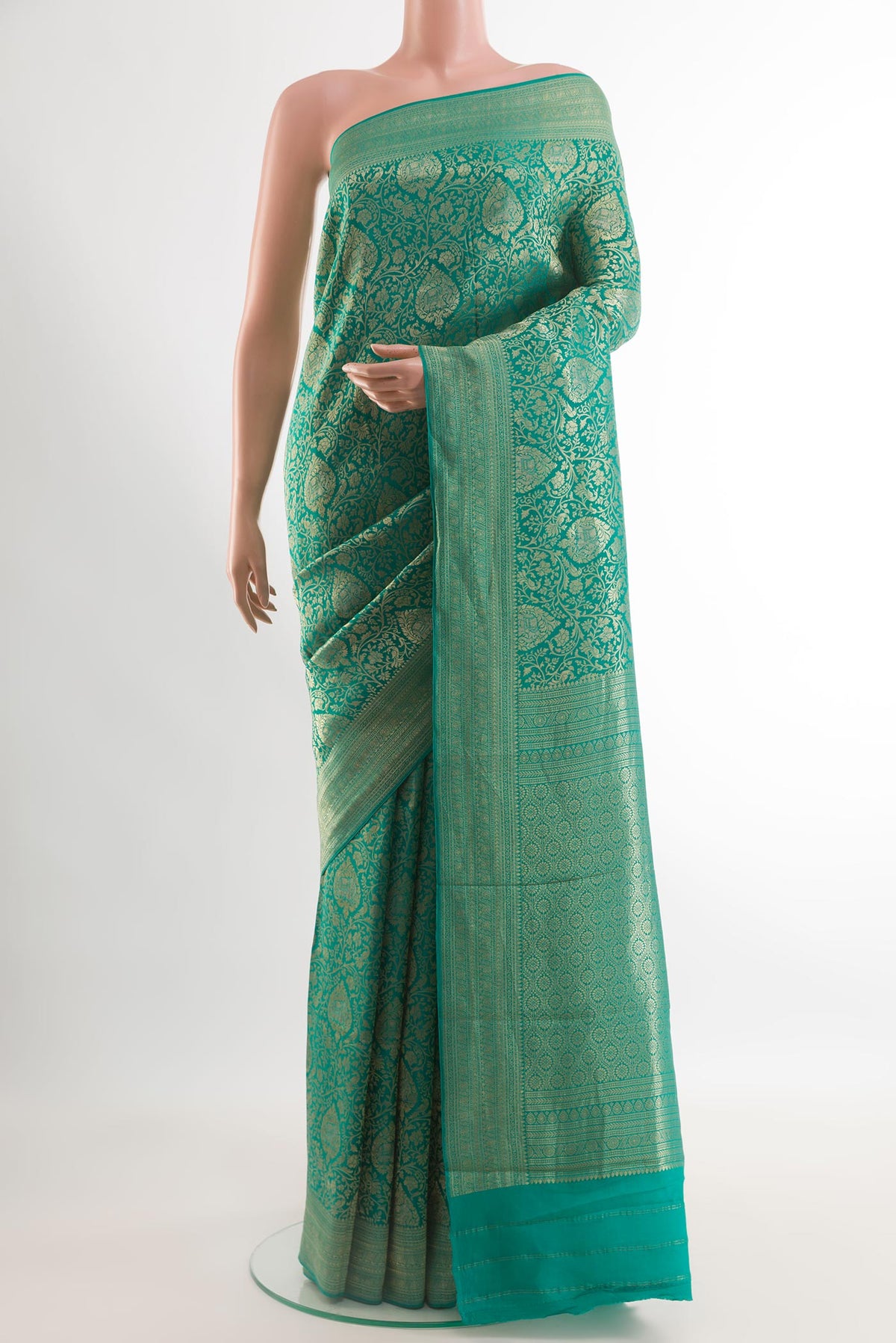 Sea Green Mysore Crepe Saree with Zari Brocade on the body and Zari Border.  displayed on a mannequin