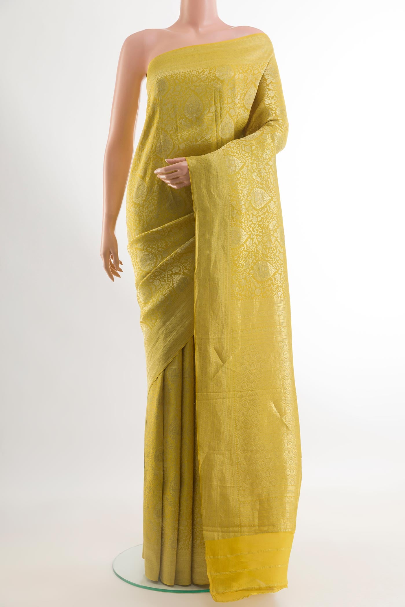 Yellow Mysore Crepe Saree with Zari Brocade on the body and Zari Border.  displayed on a mannequin