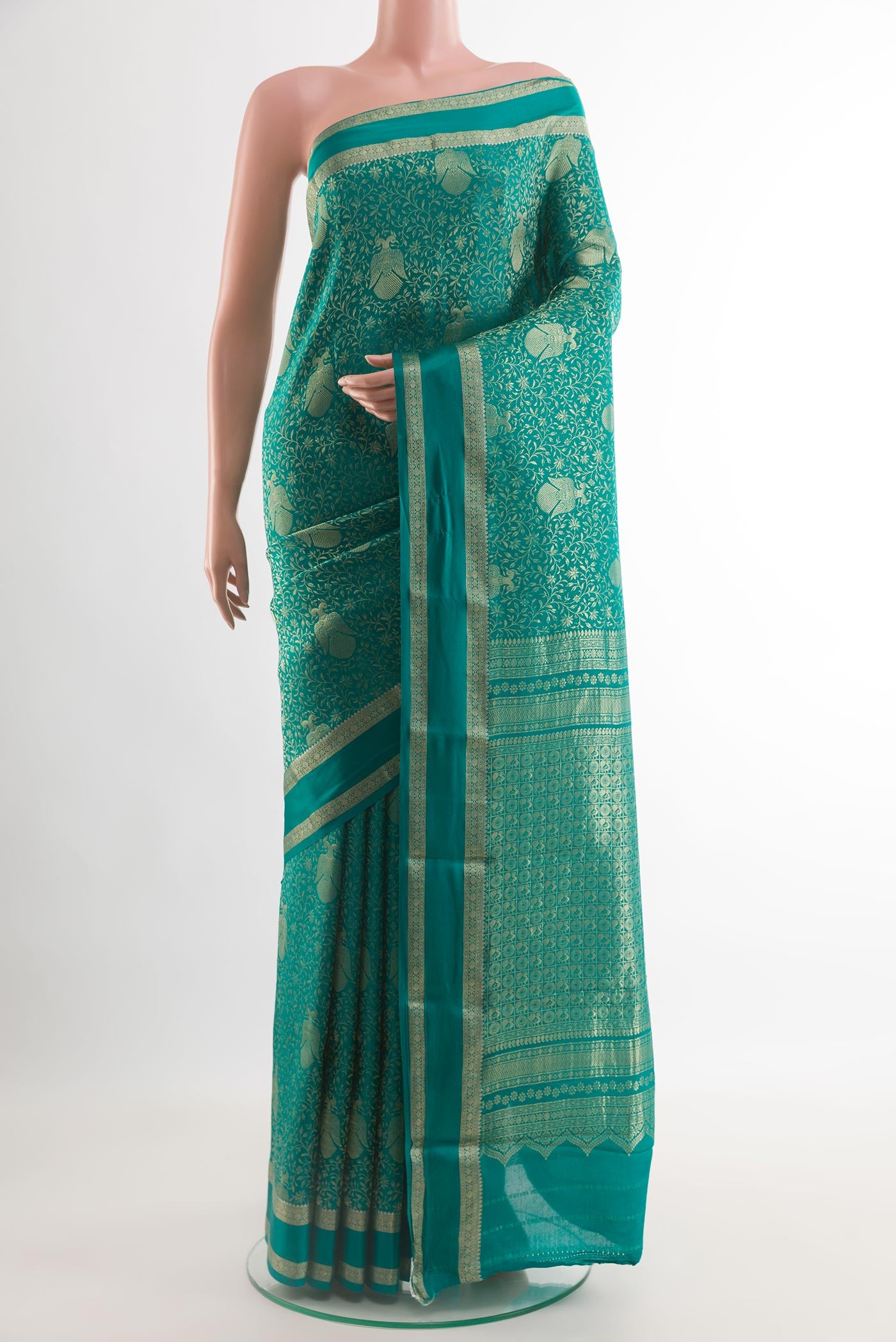 Sea Green Mysore Crepe Saree with Zari Brocade on the body and Zari Border.  displayed on a mannequin
