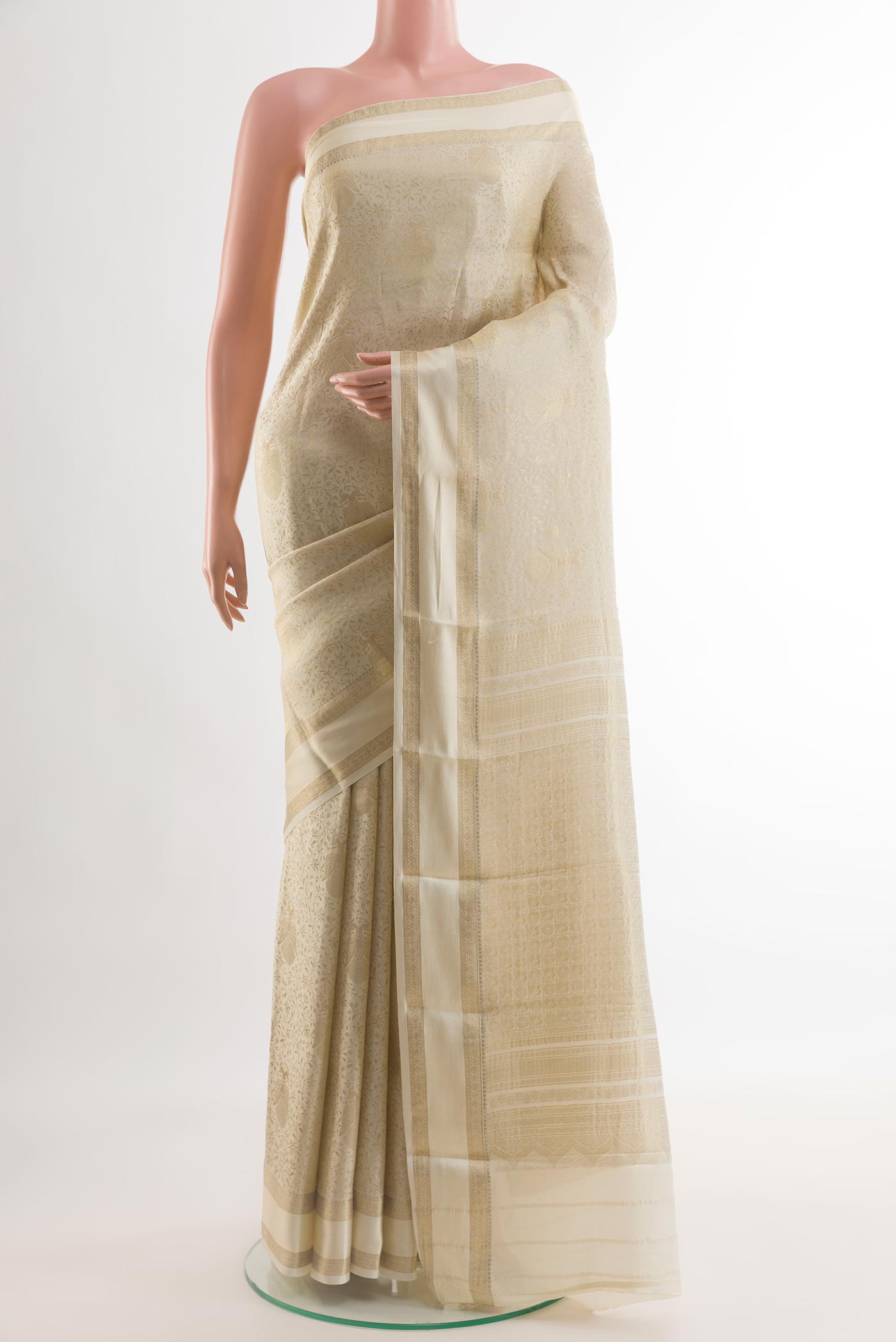 Off White Mysore Crepe Saree with Zari Brocade on the body and Zari Border.  displayed on a mannequin