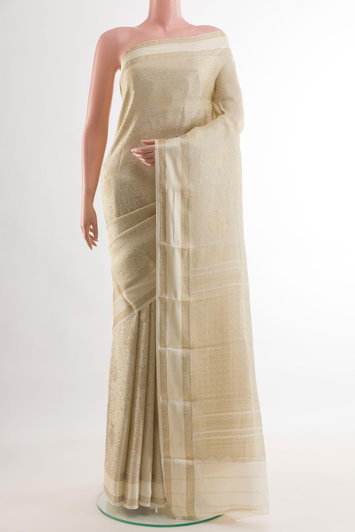 Off White Mysore Crepe Saree with Zari Brocade on the body and Zari Border.  displayed on a mannequin