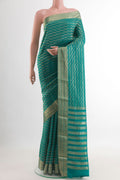 Sea Green Mysore Crepe Saree with Zari Brocade on the body and Zari Border.  displayed on a mannequin