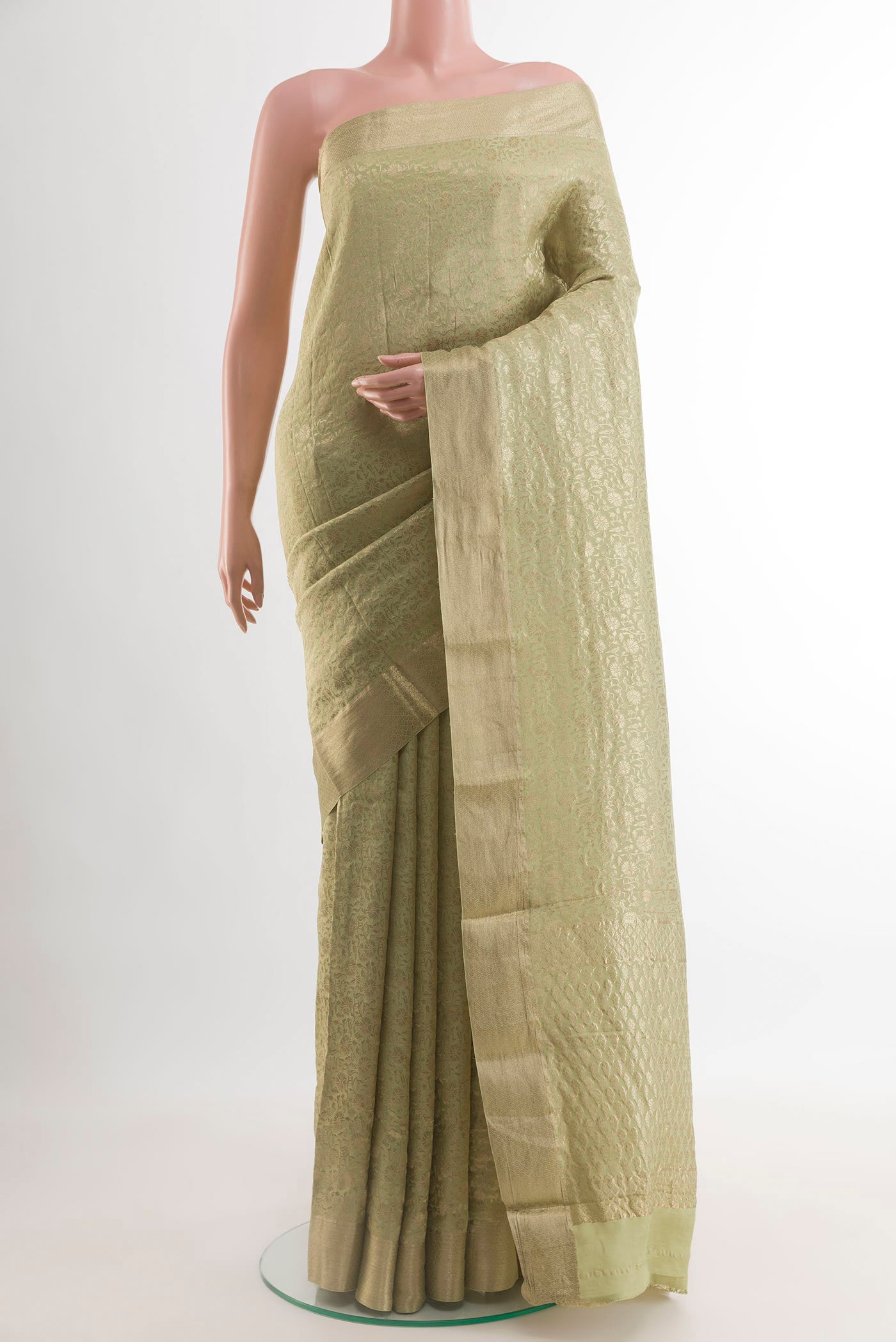 Light Green Mysore Crepe Saree with Zari Brocade on the body and Zari Border.  displayed on a mannequin