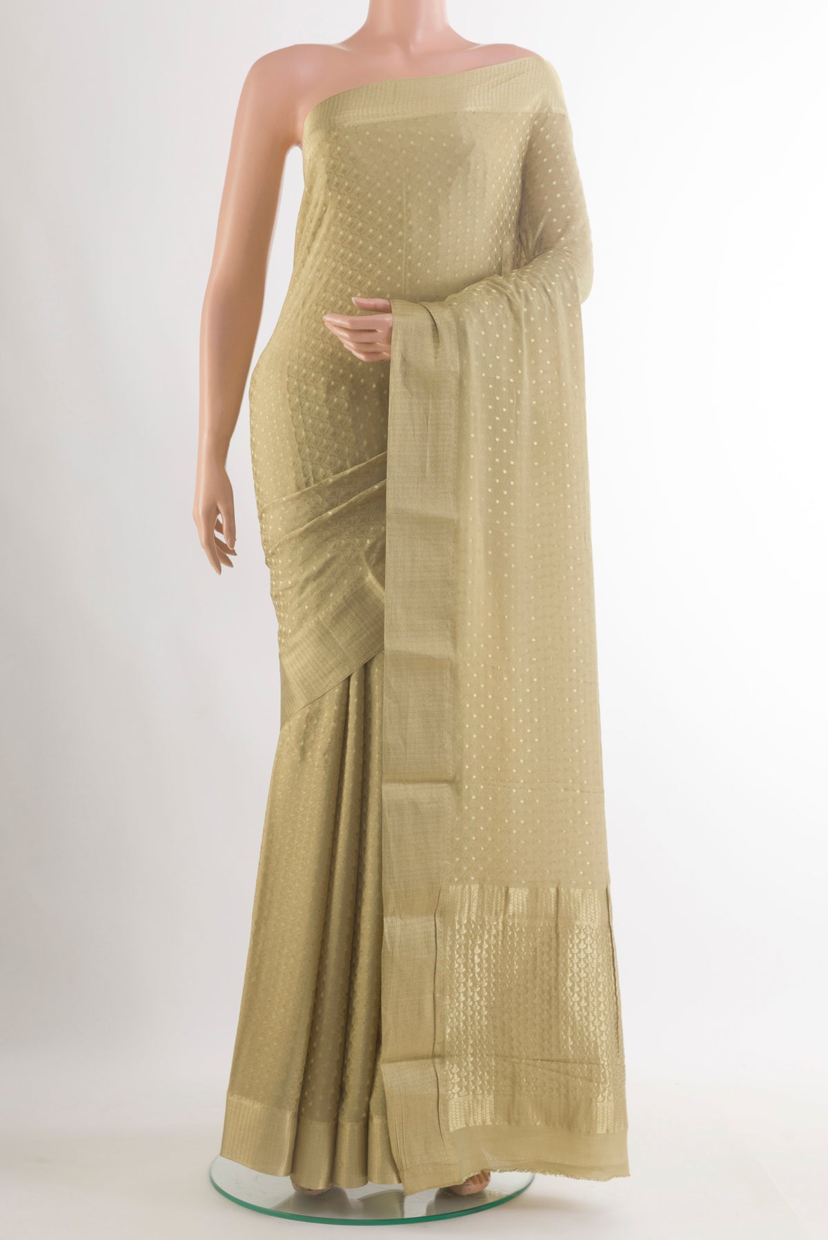 Beige Mysore Crepe Saree with Zari Butta on the body and Zari Border.  displayed on a mannequin