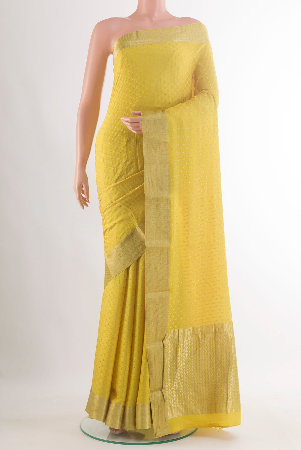 Yellow Mysore Crepe Saree with Zari Butta on the body and Zari Border.  displayed on a mannequin