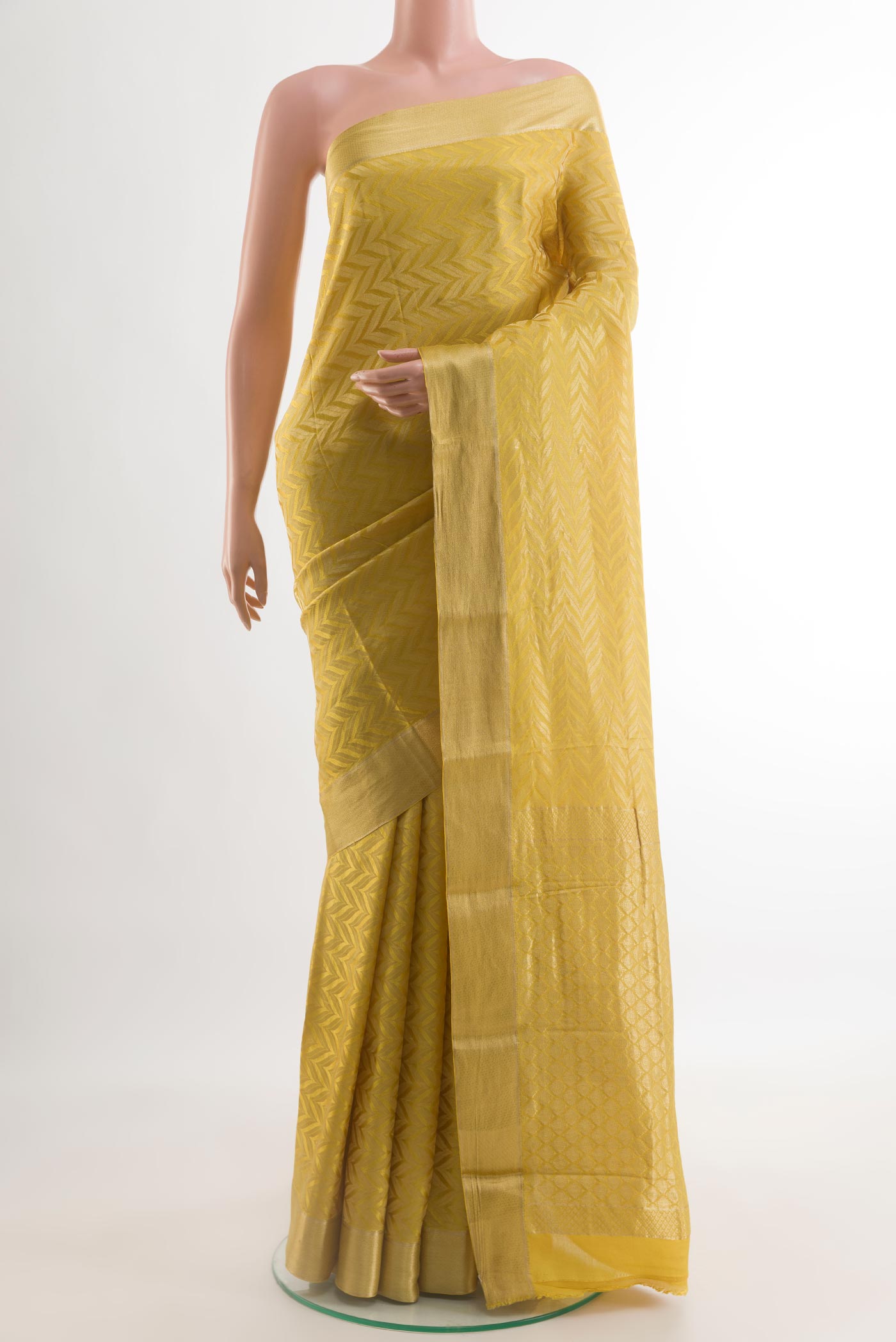 Yellow Mysore Crepe Saree with Zari Brocade on the body and Zari Border.  displayed on a mannequin