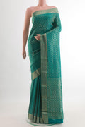 Sea Green Mysore Crepe Saree with Zari Brocade on the body and Zari Border.  displayed on a mannequin