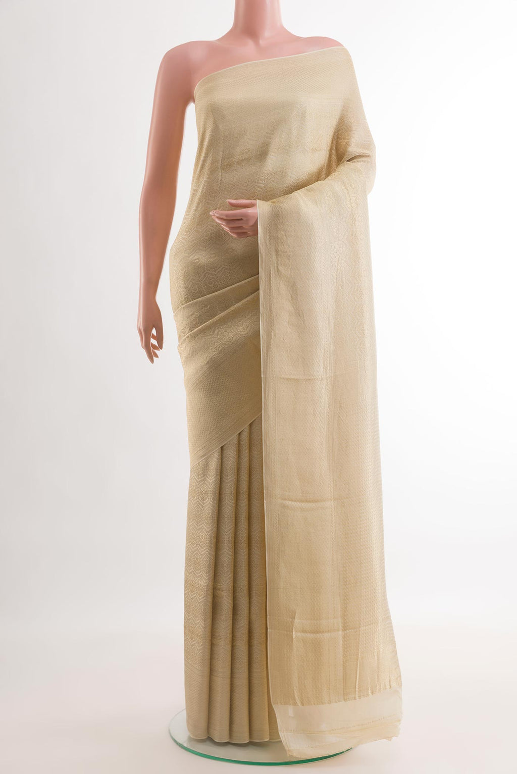 Off White Mysore Crepe Saree with Zari Brocade on the body and Zari Border.  displayed on a mannequin