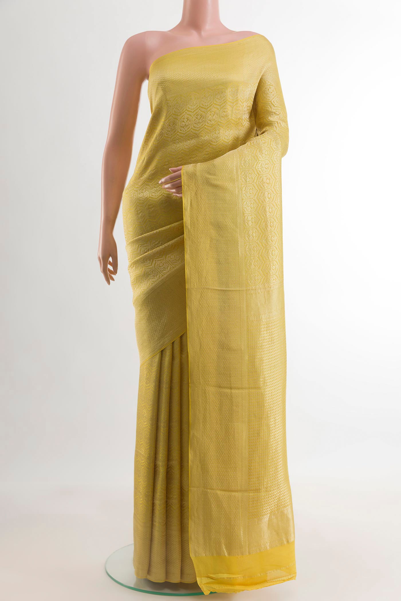 Yellow Mysore Crepe Saree with Zari Brocade on the body and Zari Border.  displayed on a mannequin