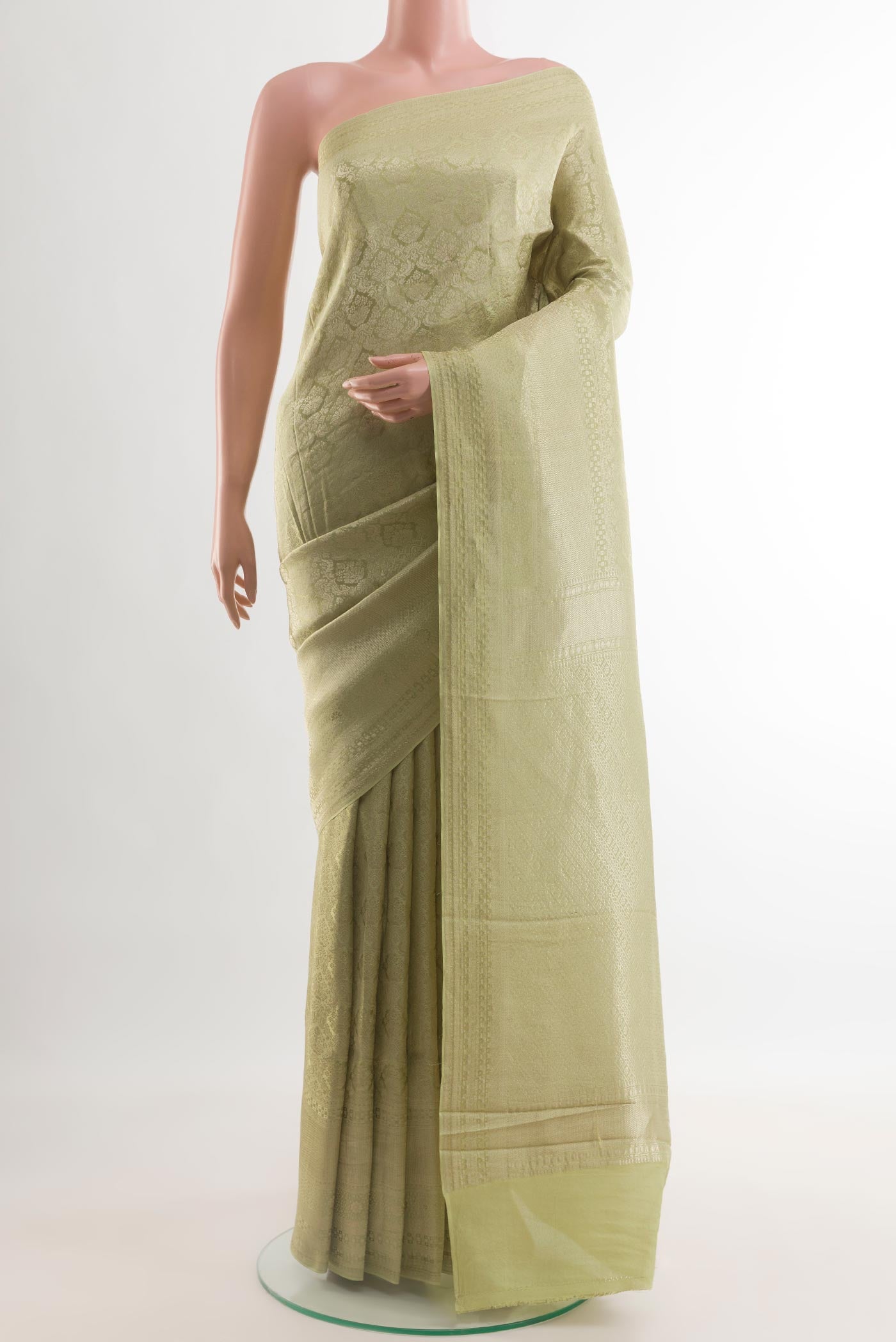 Light Green Mysore Crepe Saree with Zari Brocade on the body and Zari Border.  displayed on a mannequin