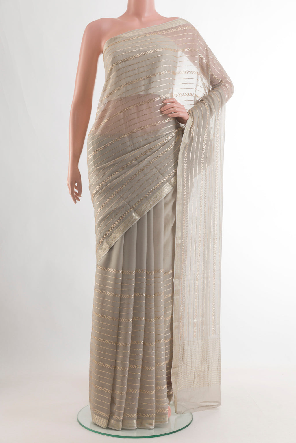 Grey Mysore Chiffon Saree with Stripes on the body and Zari Border.  displayed on a mannequin