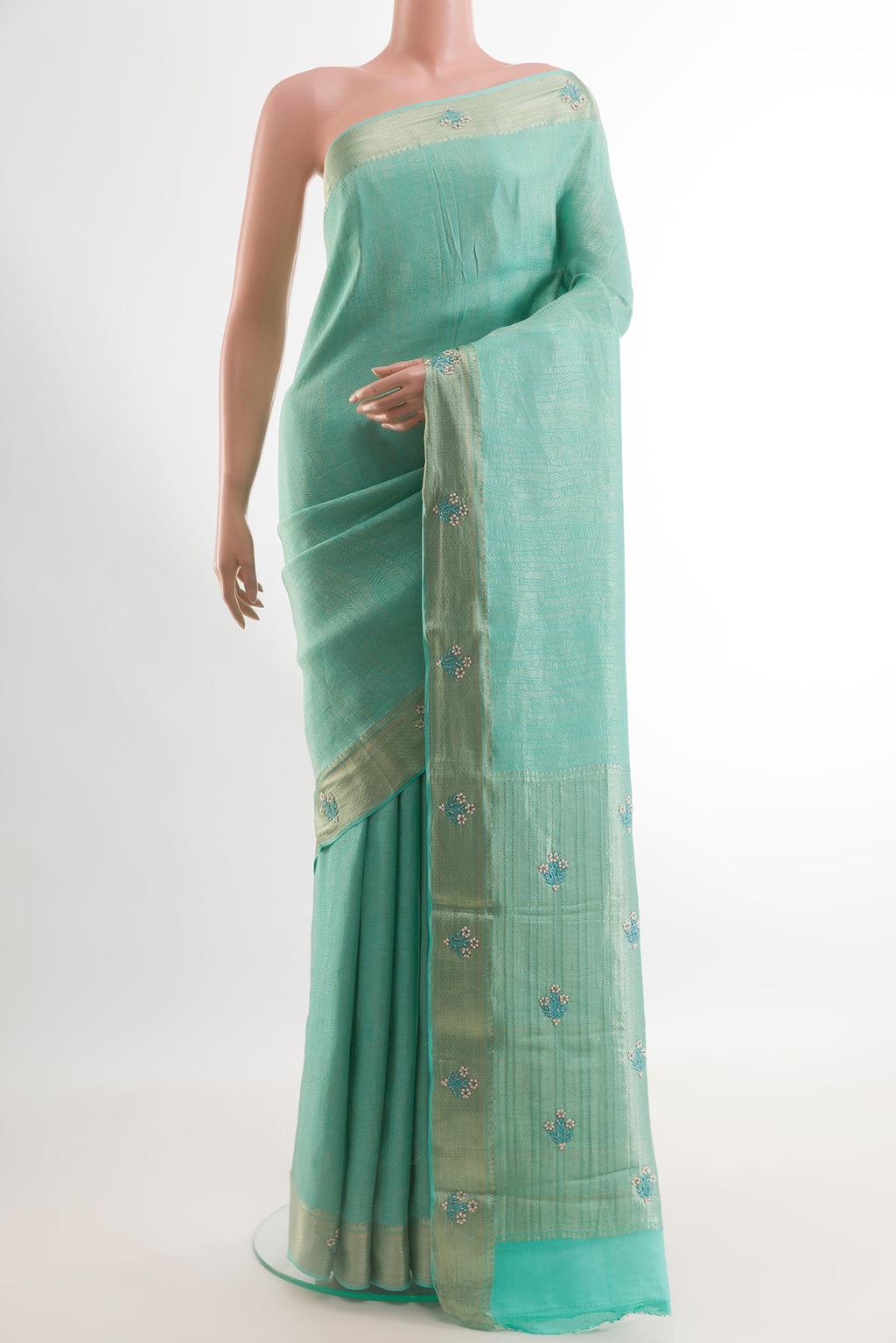 Turquoise Mysore Crepe Saree with Zari Brocade on the body and Zari Border.  displayed on a mannequin