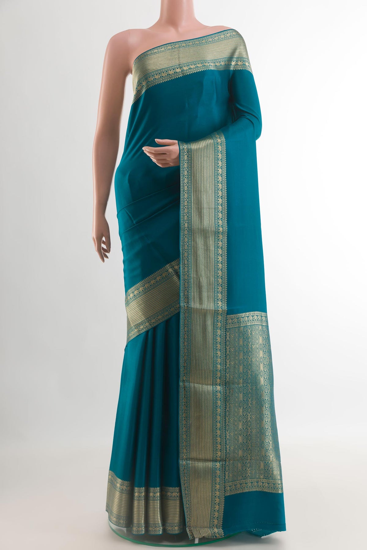 Peacock Blue Mysore Crepe Saree with Plain Body and Zari Border.  displayed on a mannequin