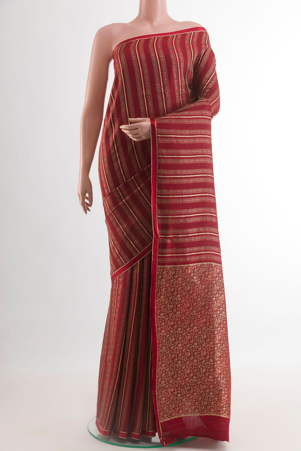 Maroon Mysore Crepe Saree with Stripes on the body and Zari Border.  displayed on a mannequin