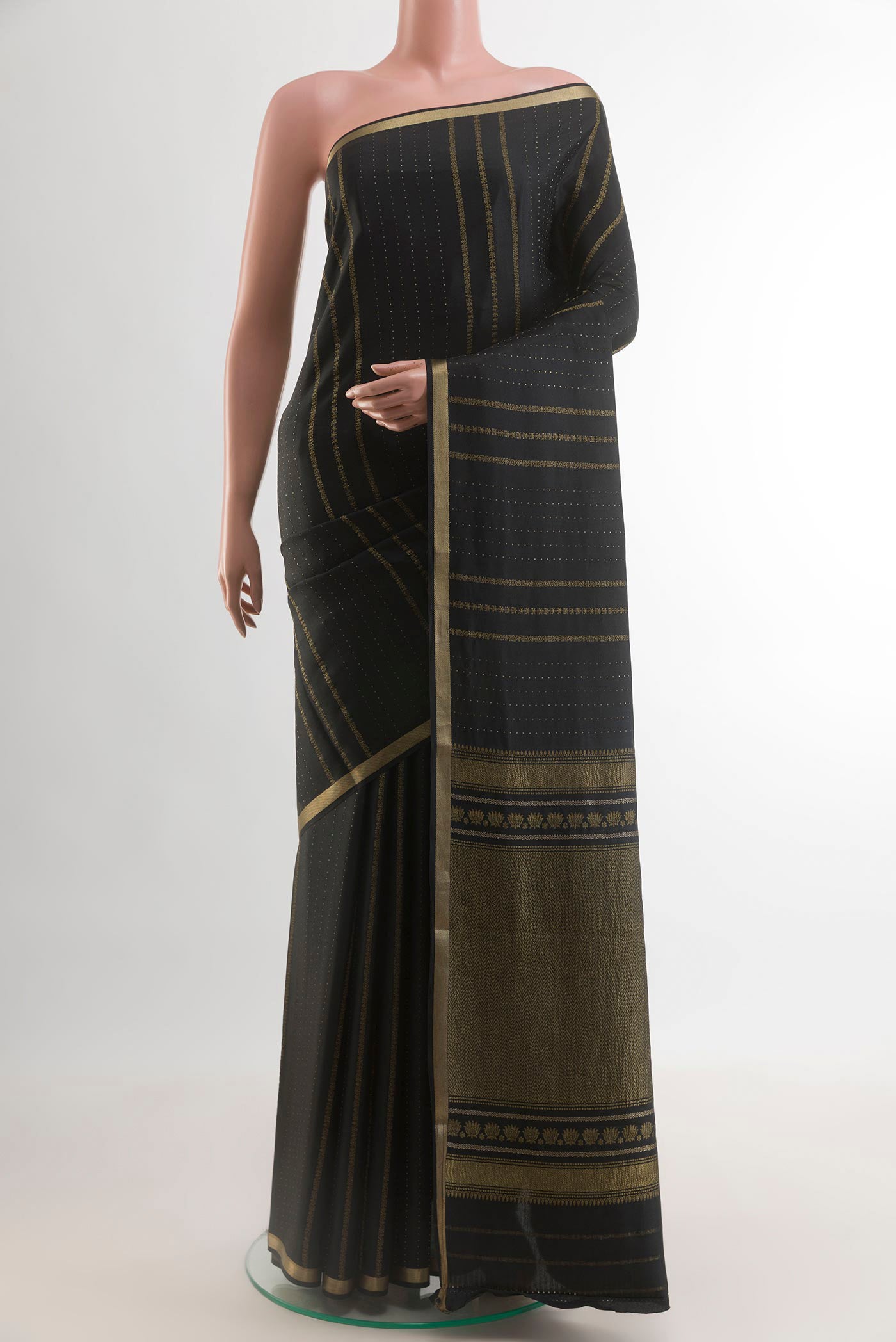 Black Mysore Crepe Saree with Stripes on the body and Zari Border.  displayed on a mannequin