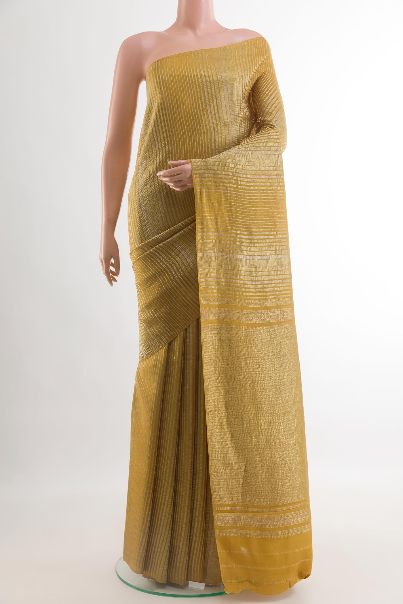 Mustard Mysore Crepe Saree with Stripes on the body and Zari Border.  displayed on a mannequin