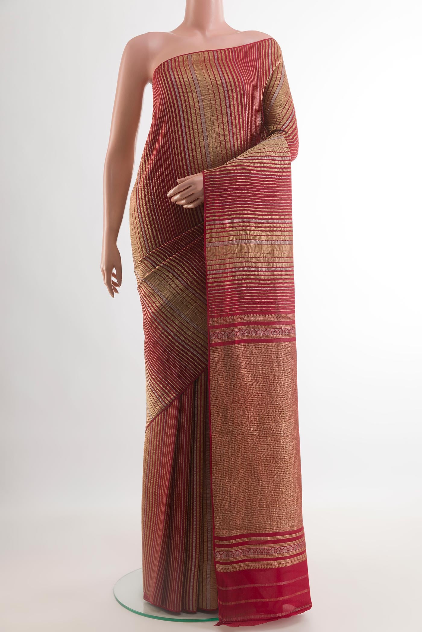 Red Mysore Crepe Saree with Stripes on the body and Zari Border.  displayed on a mannequin
