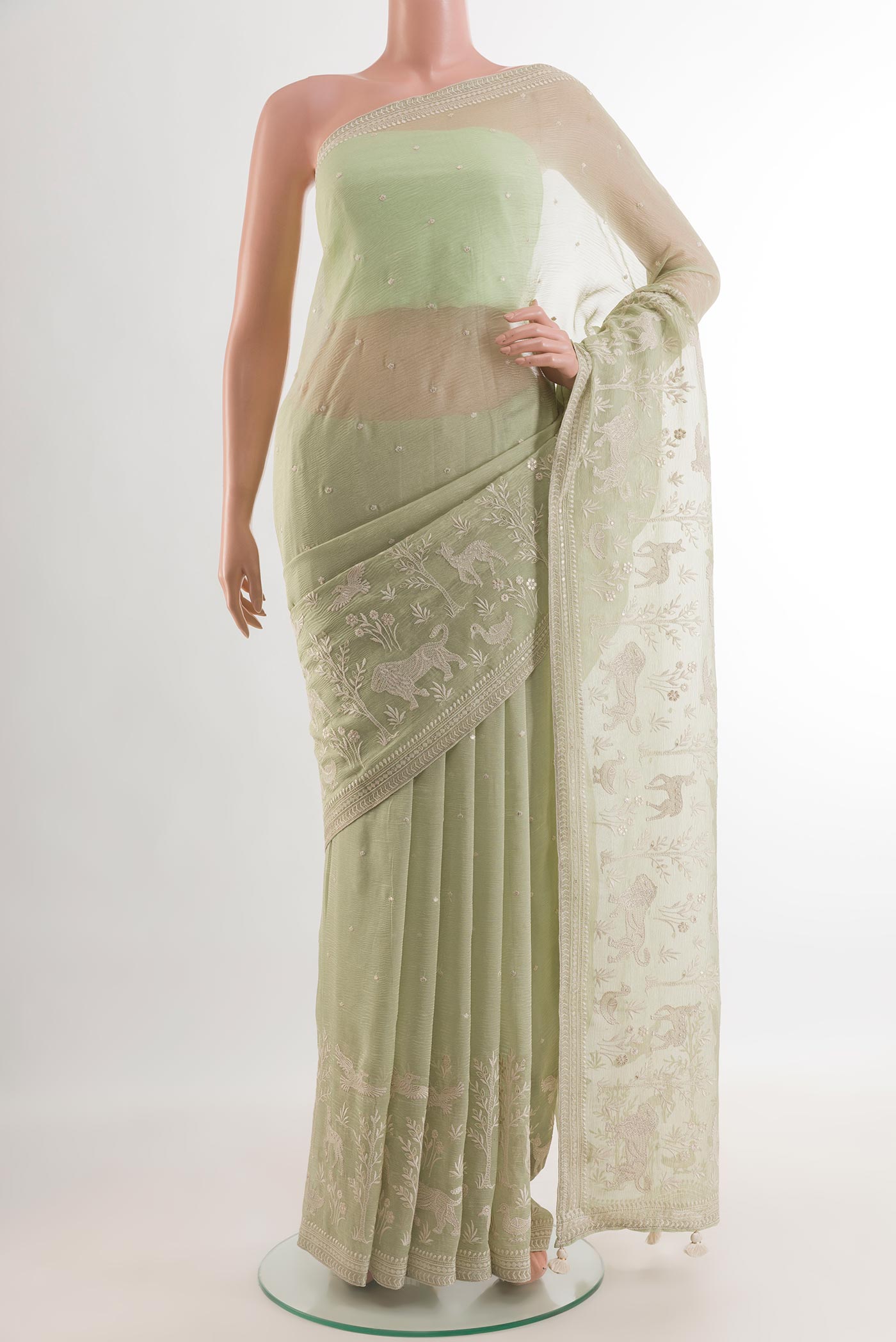 Light Green Mysore Georgette Saree with Embroidery on the body and Zari Border.  displayed on a mannequin