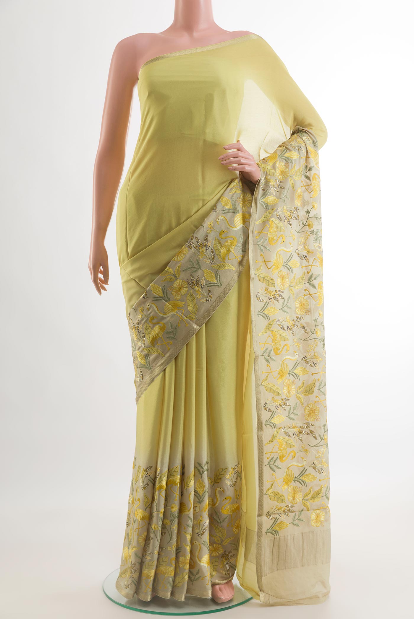 Lemon Yellow Mysore Crepe Saree with Plain Body and Zari Border.  displayed on a mannequin