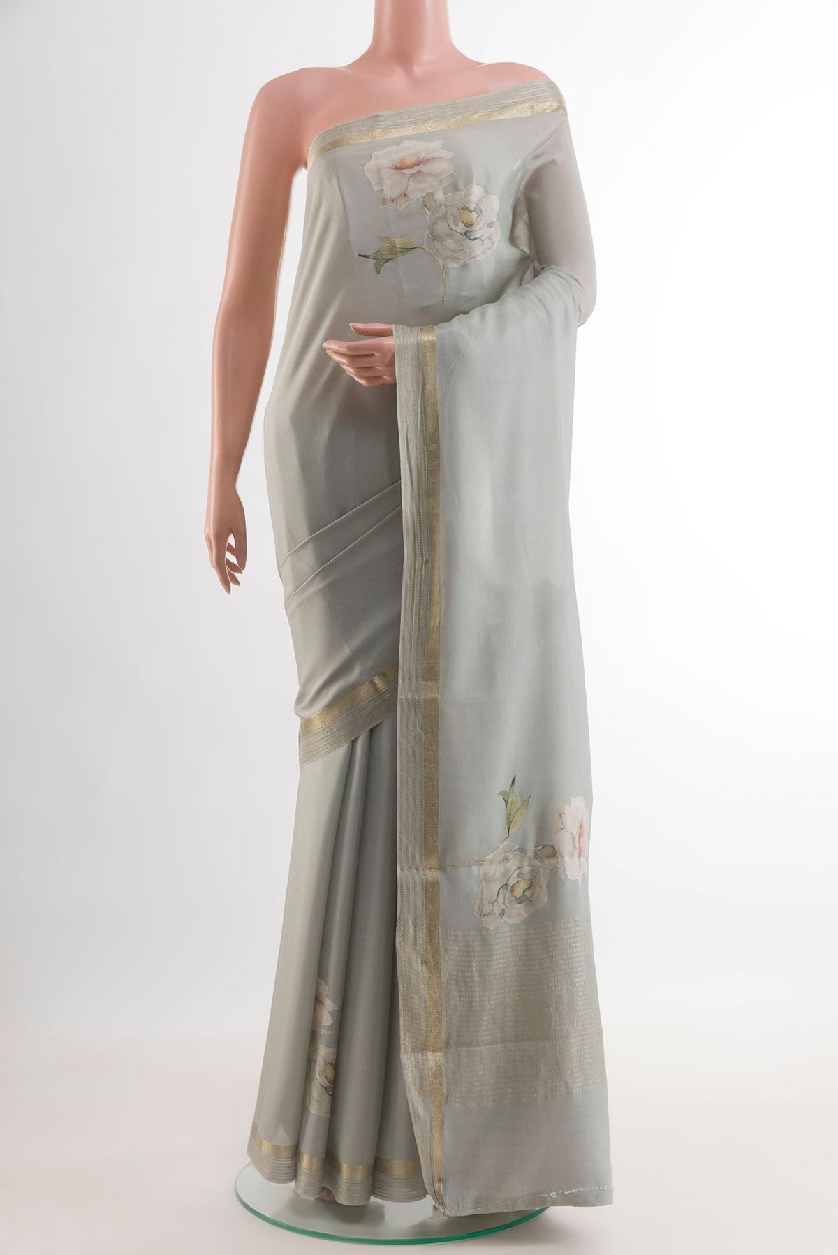 Grey Mysore Crepe Saree with Floral Print on the body and Zari Border.  displayed on a mannequin
