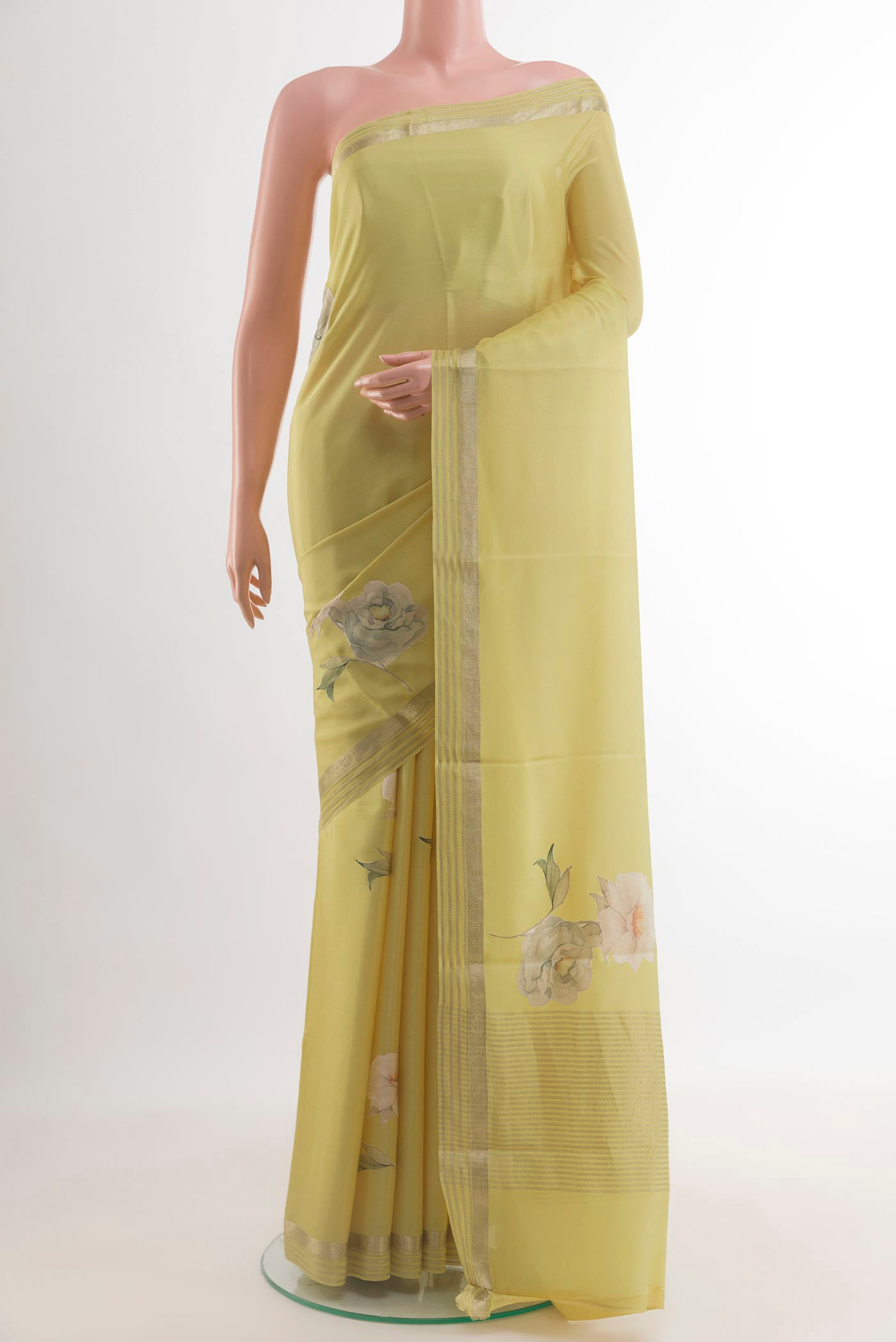 Lemon Yellow Mysore Crepe Saree with Floral Print on the body and Zari Border.  displayed on a mannequin