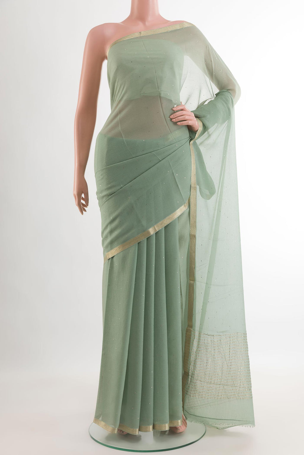 Sage Green Chiffon Saree with Embroidery on the body and Zari Border.  displayed on a mannequin