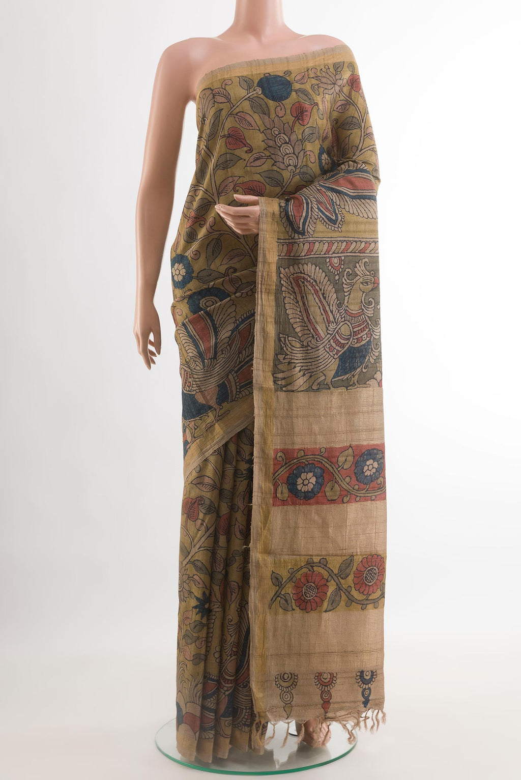 Beige Tussar Silk Saree with kalamkari Print on the body and Zari Border.  displayed on a mannequin