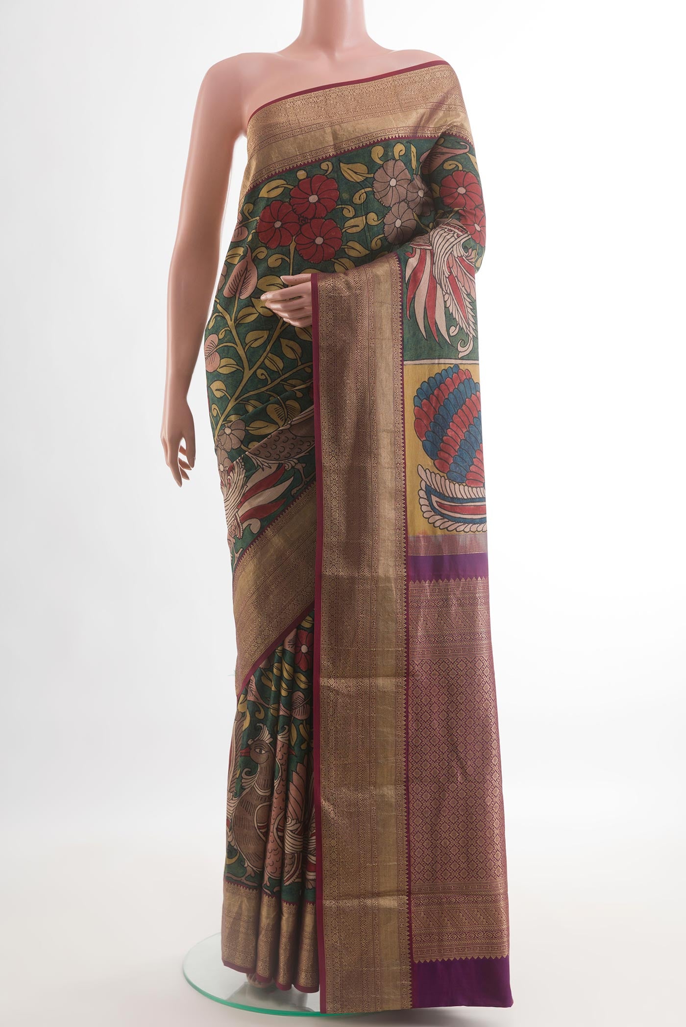 Green Kanjivaram Silk Saree with kalamkari Print on the body and Zari Border.  displayed on a mannequin