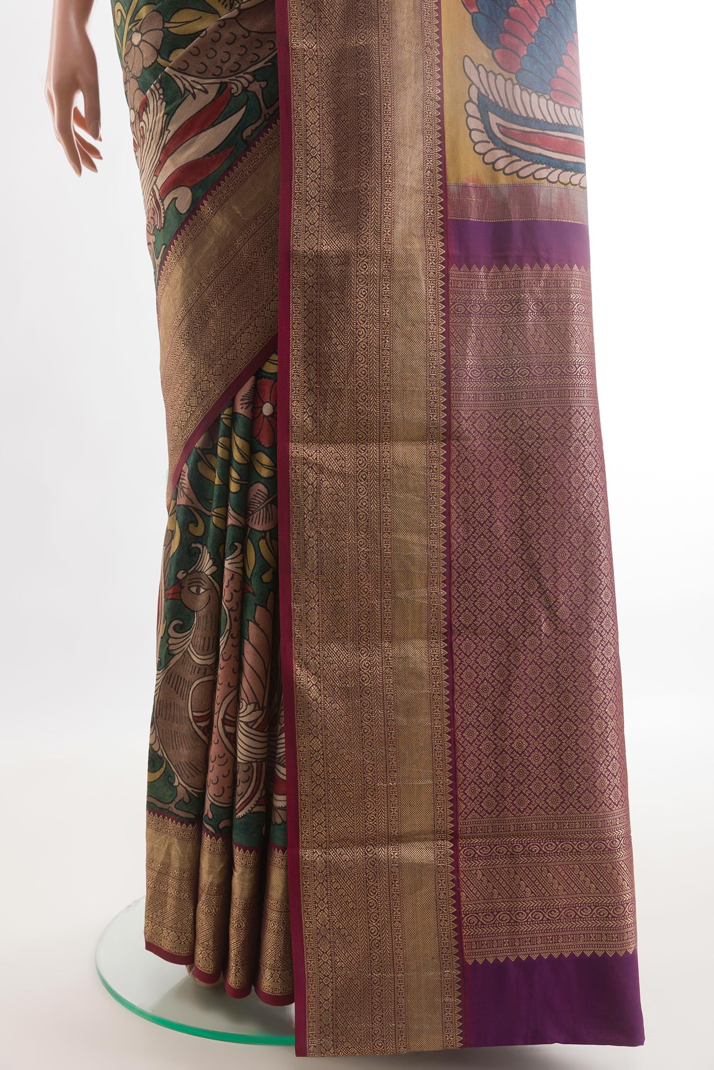 Pleats and pallu of Green Kanjivaram Silk Saree with kalamkari Print on the body and Zari Border. 