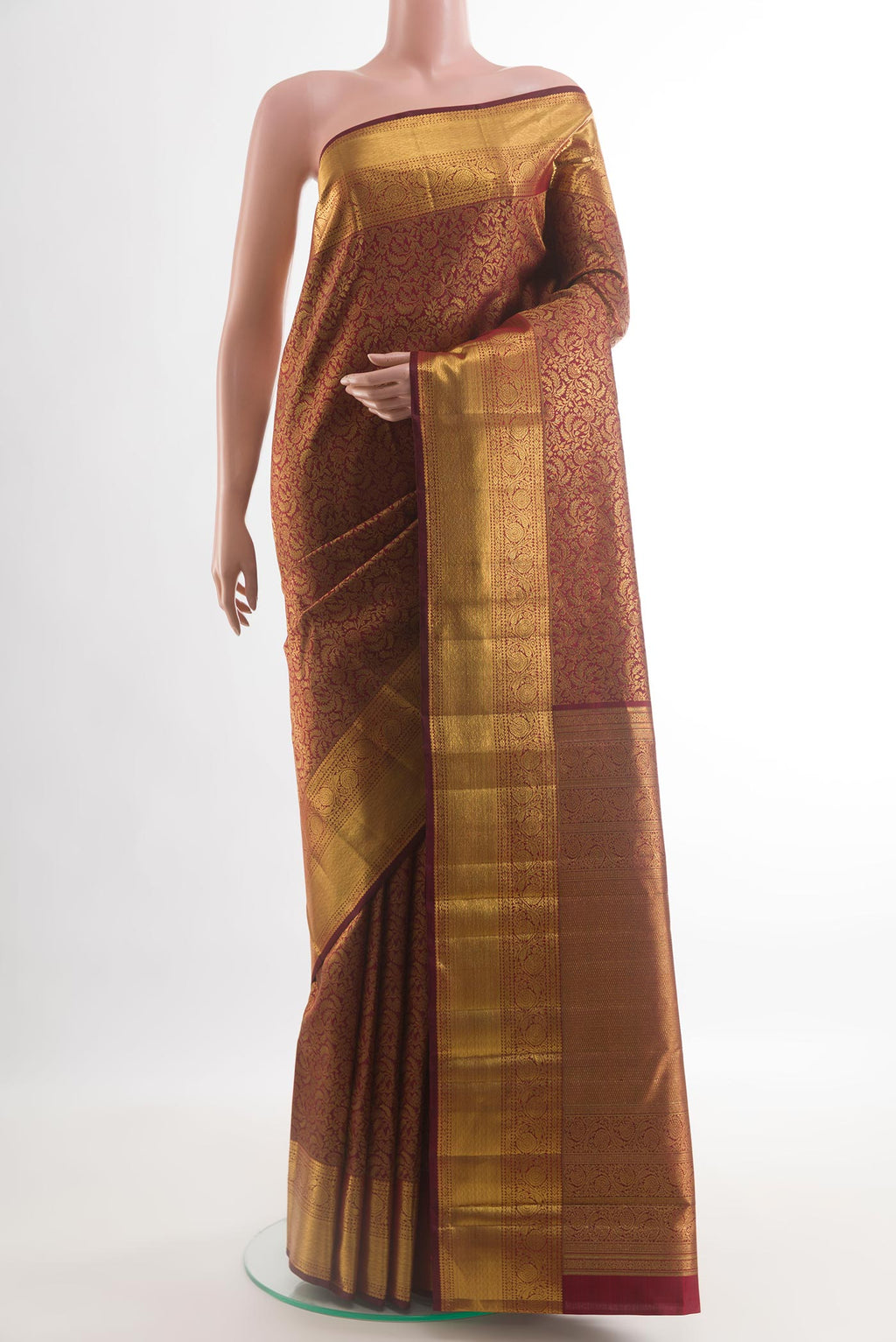 Maroon Kanchipuram Silk Saree with Zari Brocade on the body and Zari Border.  displayed on a mannequin