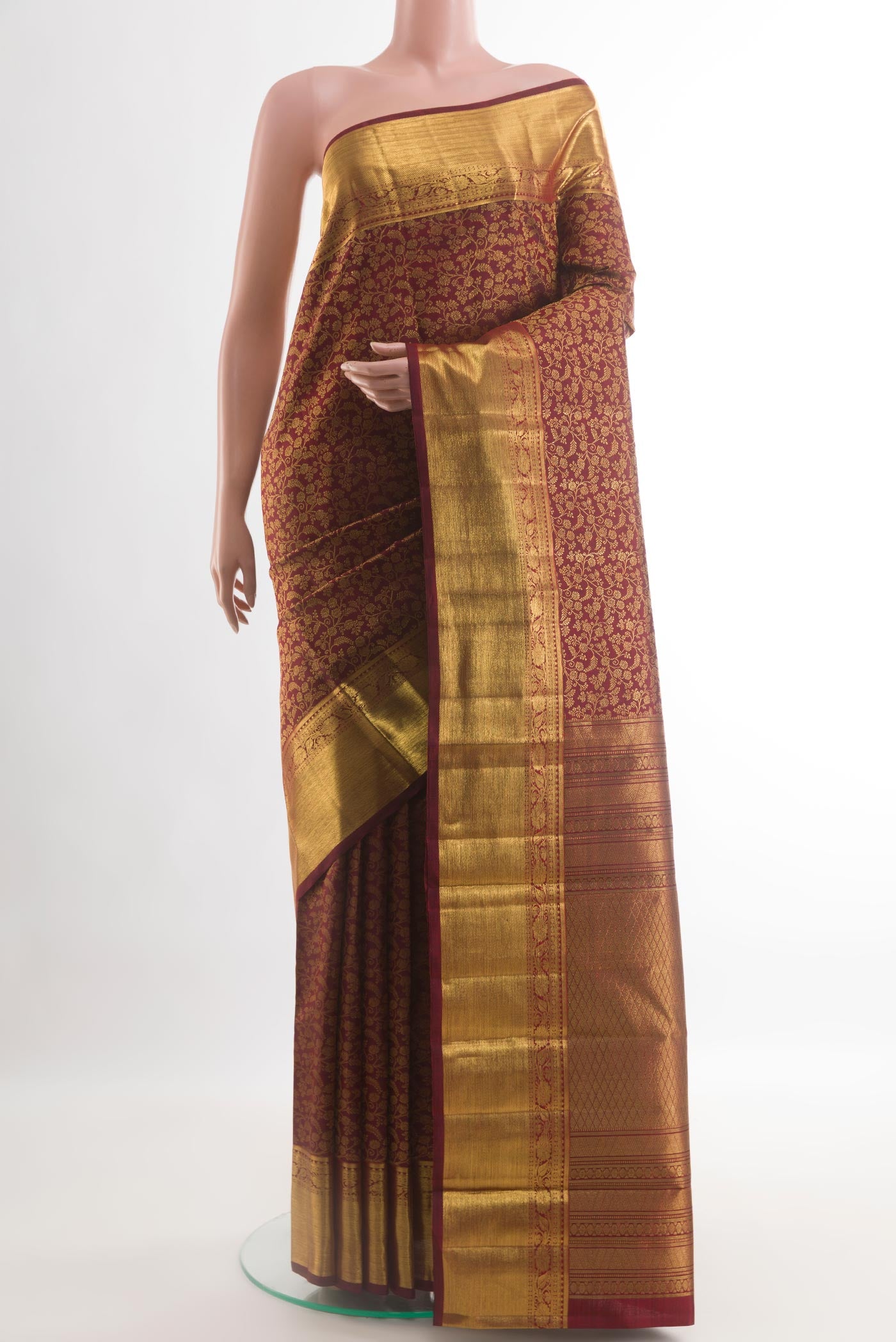 Maroon Kanchipuram Silk Saree with Zari Brocade on the body and Zari Border.  displayed on a mannequin