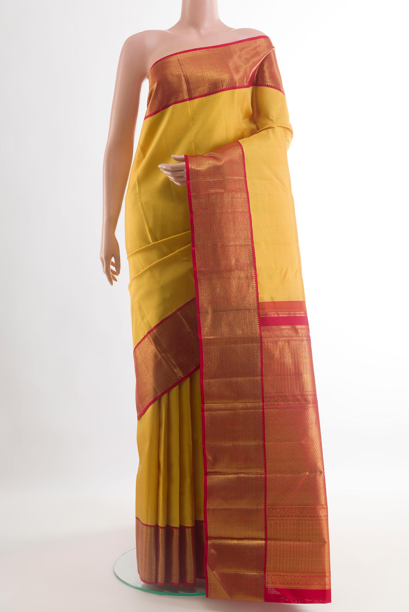Yellow Kanjivaram Silk Saree with Zari Brocade on the body and Zari Border.  displayed on a mannequin