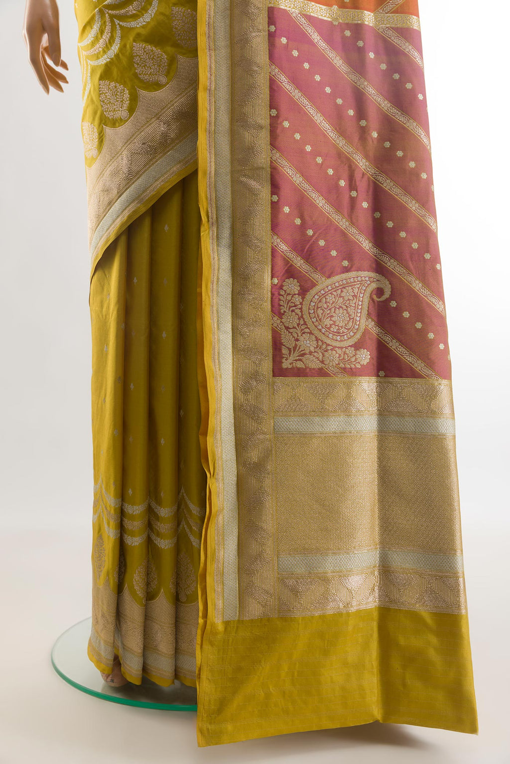 Pleats and pallu of Mehandi Green Banarasi Silk Saree with Zari Butta on the body and Zari Border. 
