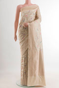 Cream Banarasi Silk Saree with Zari Brocade on the body and Zari Border.  displayed on a mannequin