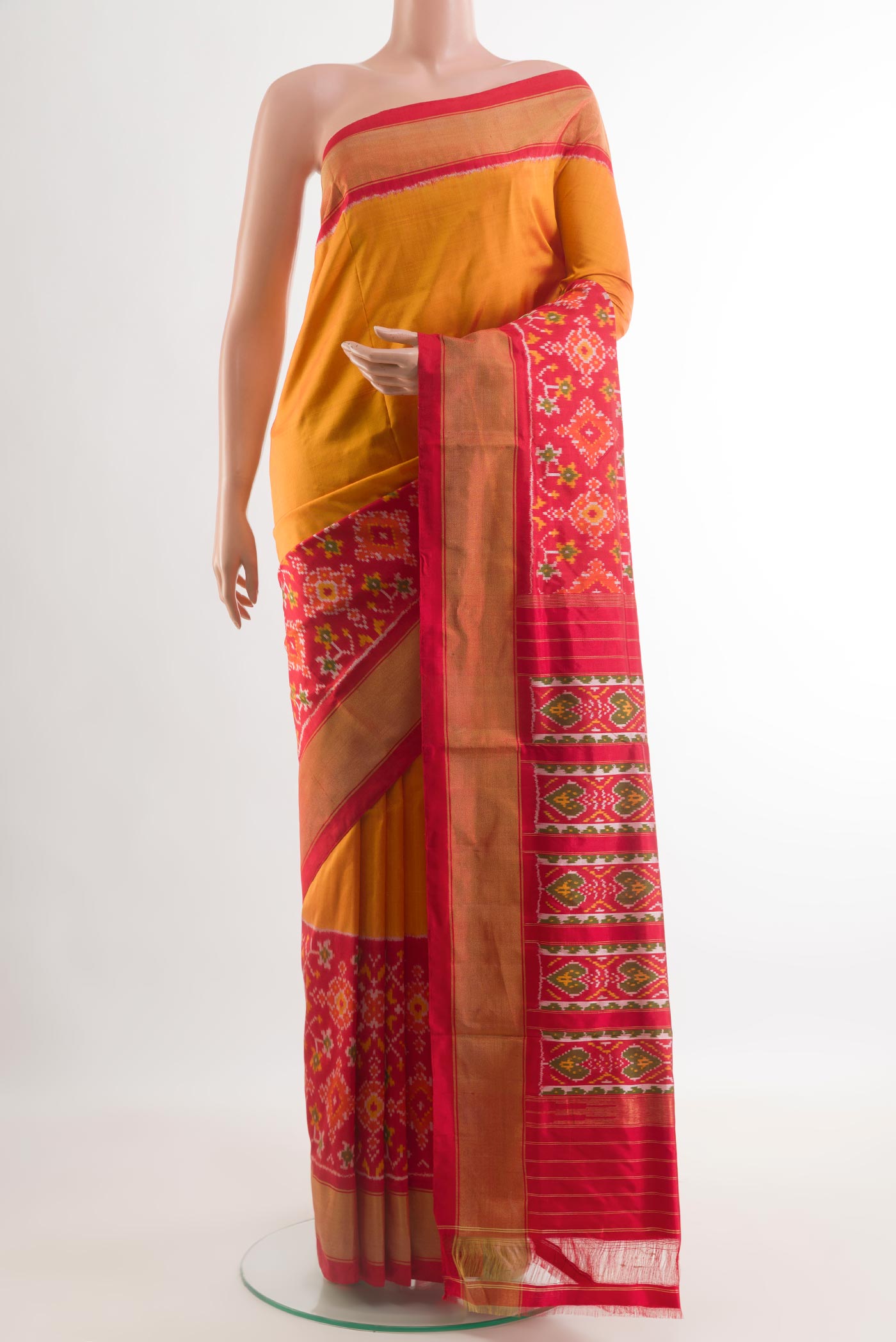 Mustard Pochampally Silk Saree with Plain Body and Ikat Border.  displayed on a mannequin