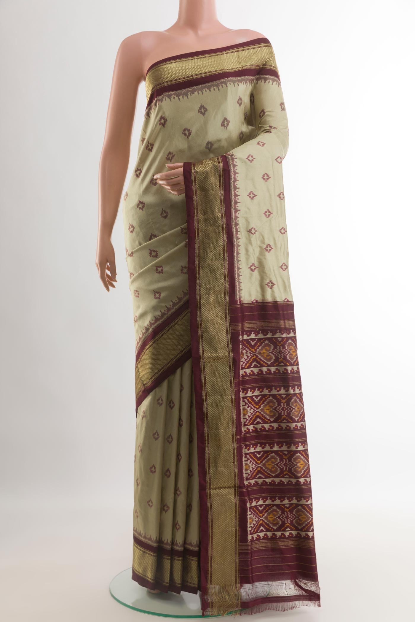 Cream Pochampally Silk Saree with Pure Ikat on the body and Zari Border.  displayed on a mannequin