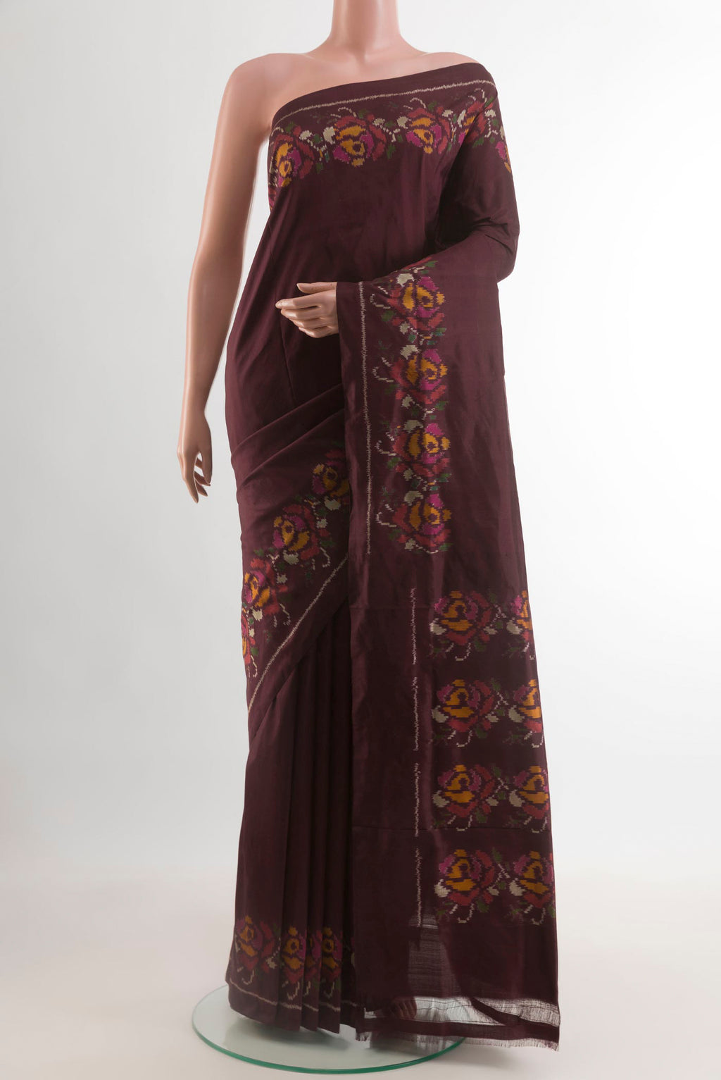 Brown Pochampally Silk Saree with Plain Body and Ikat Border.  displayed on a mannequin