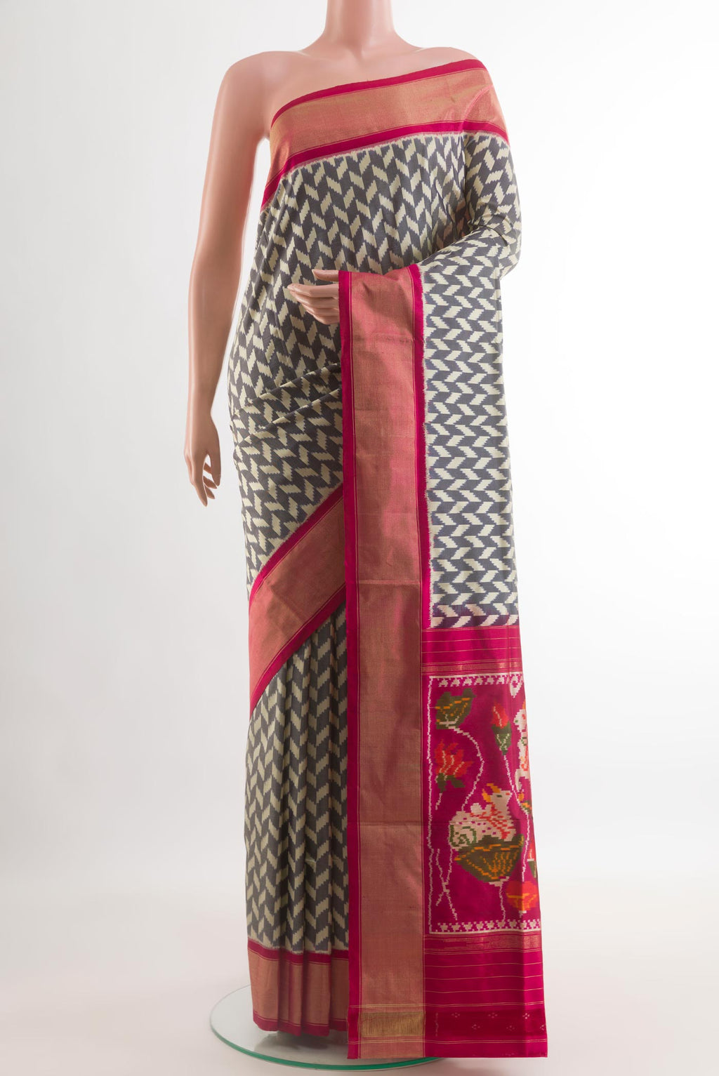 Grey Pochampally Silk Saree with Pure Ikat on the body and Ikat Border.  displayed on a mannequin
