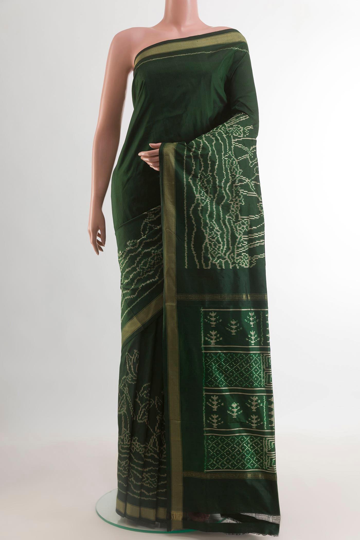 Bottle Green Pochampally Silk Saree with Ikat design on the body and Ikat Border.  displayed on a mannequin