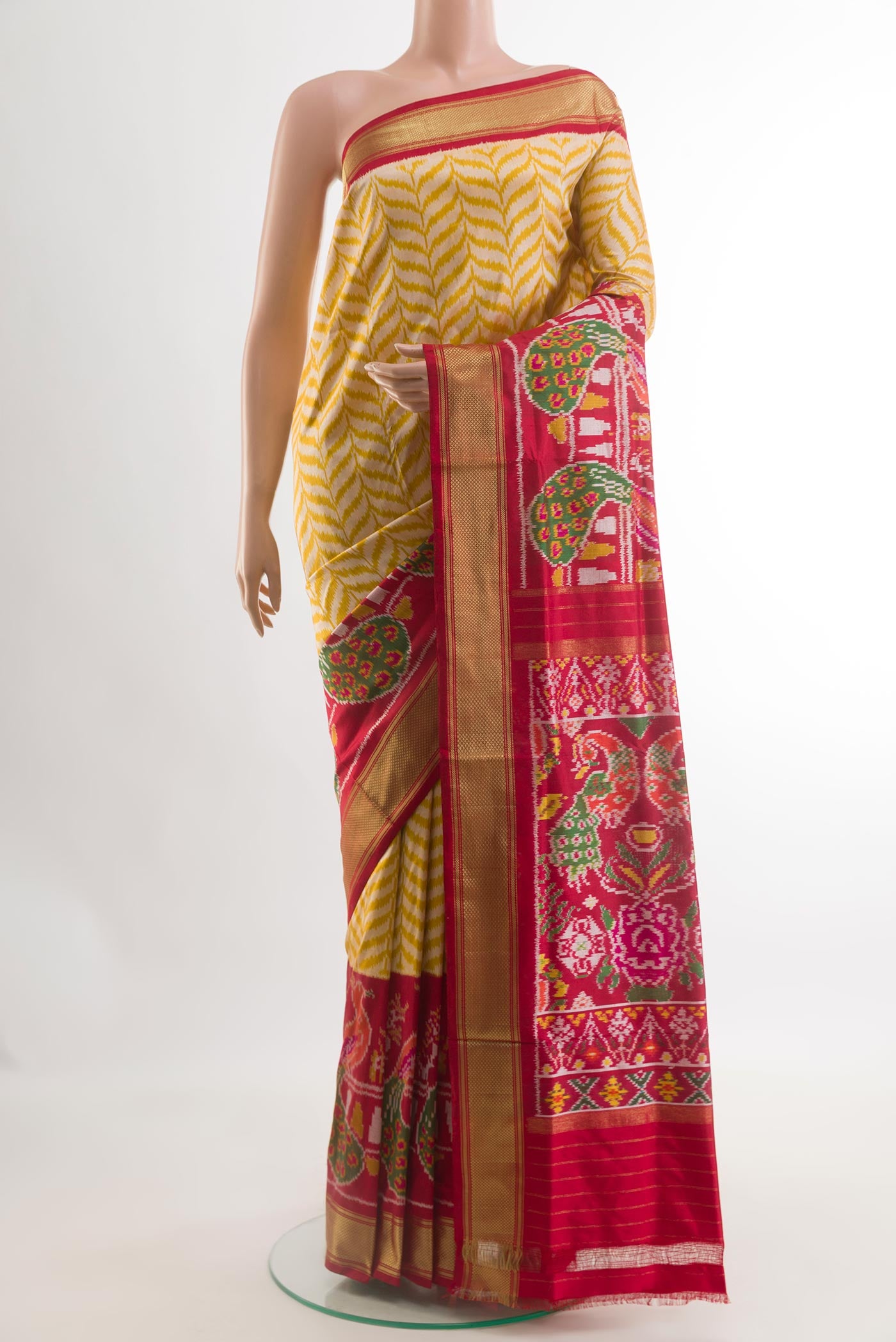 Yellow Pochampally Silk Saree with Pure Ikat on the body and Ikat Border.  displayed on a mannequin