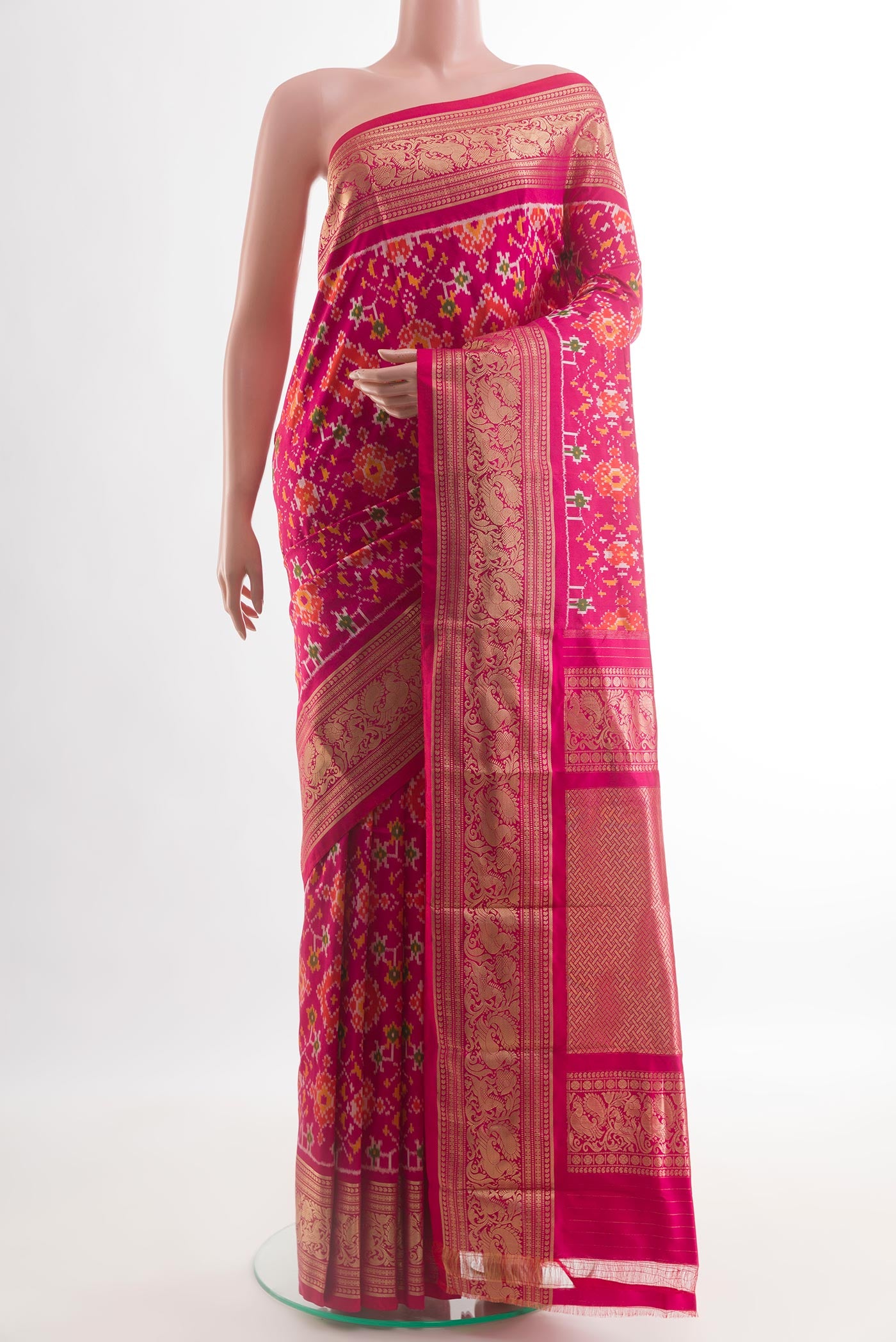 Pink Pochampally Silk Saree with Ikat design on the body and Zari Border.  displayed on a mannequin