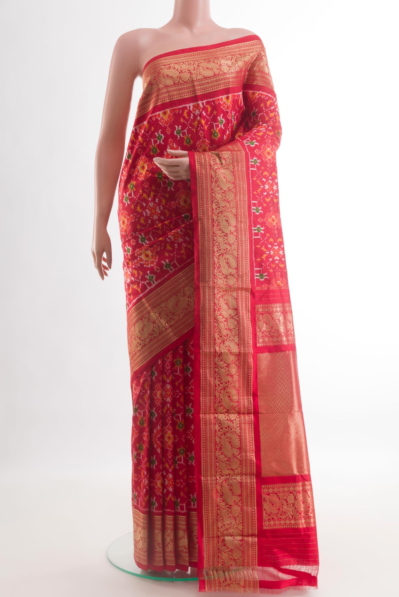 Red Pochampally Silk Saree with Pure Ikat on the body and Zari Border.  displayed on a mannequin
