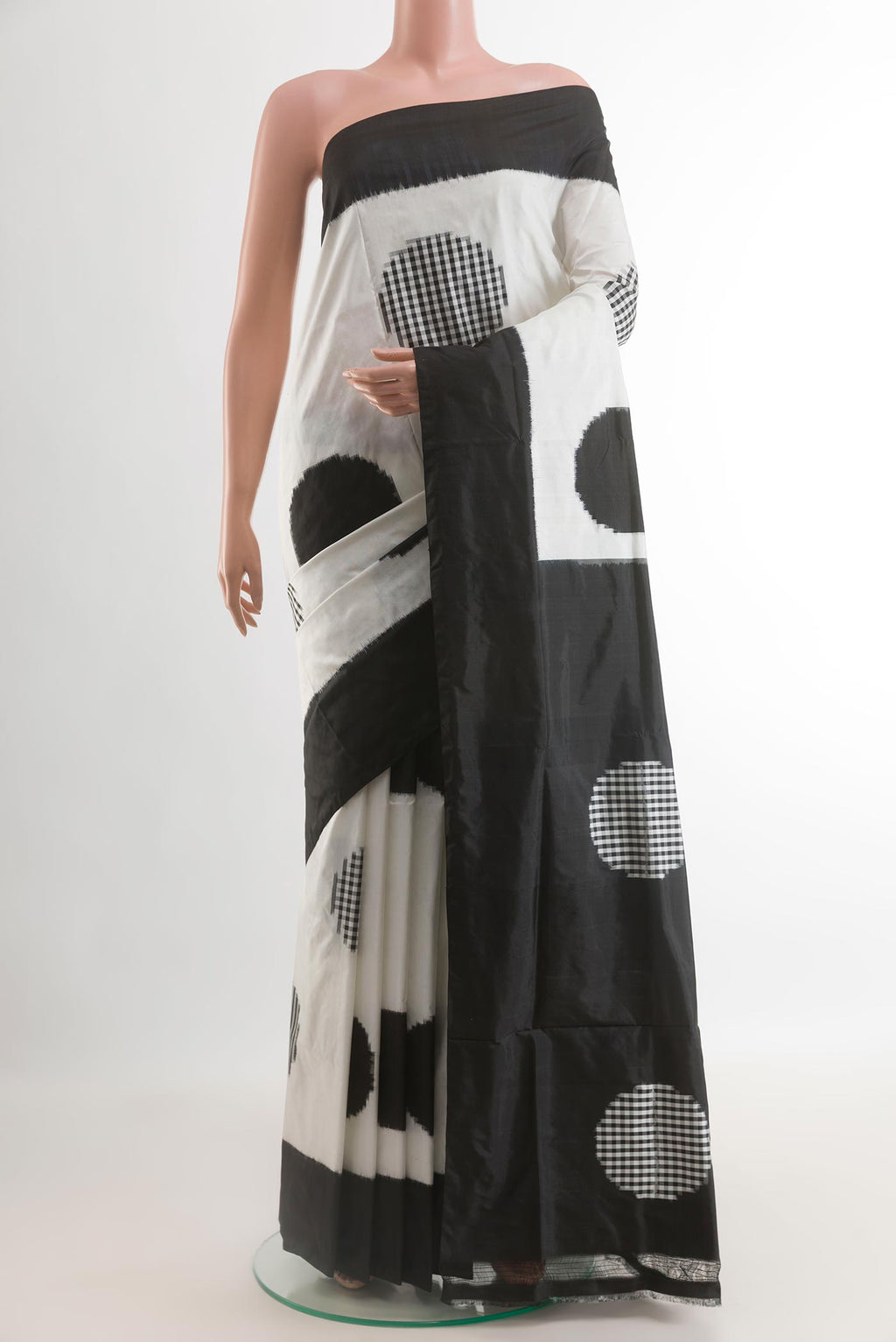 White Pochampally Silk Saree with Pure Ikat on the body and Plain Border.  displayed on a mannequin