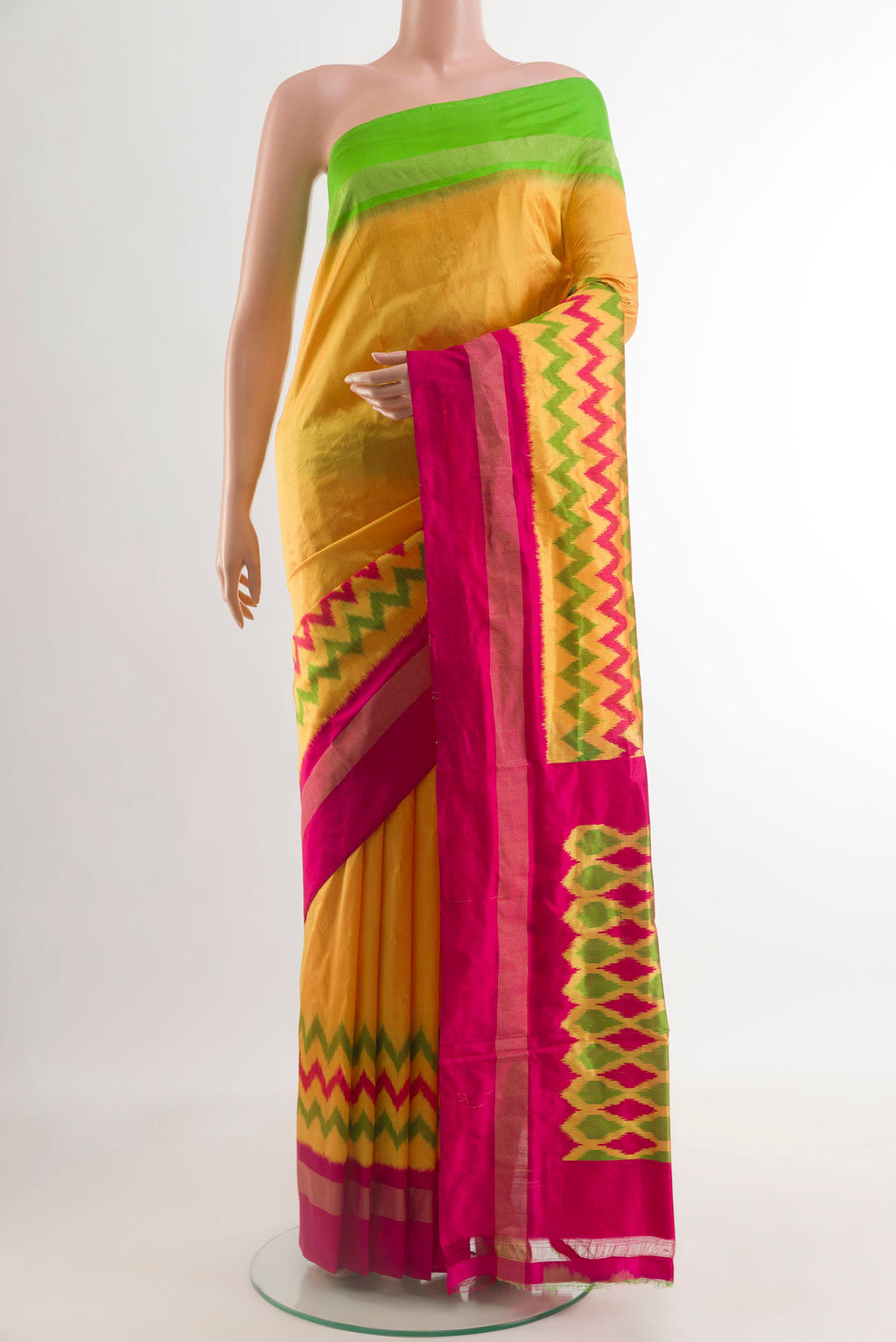 Yellow Pochampally Silk Saree with Pure Ikat on the body and Ganga Jamuna Border.  displayed on a mannequin